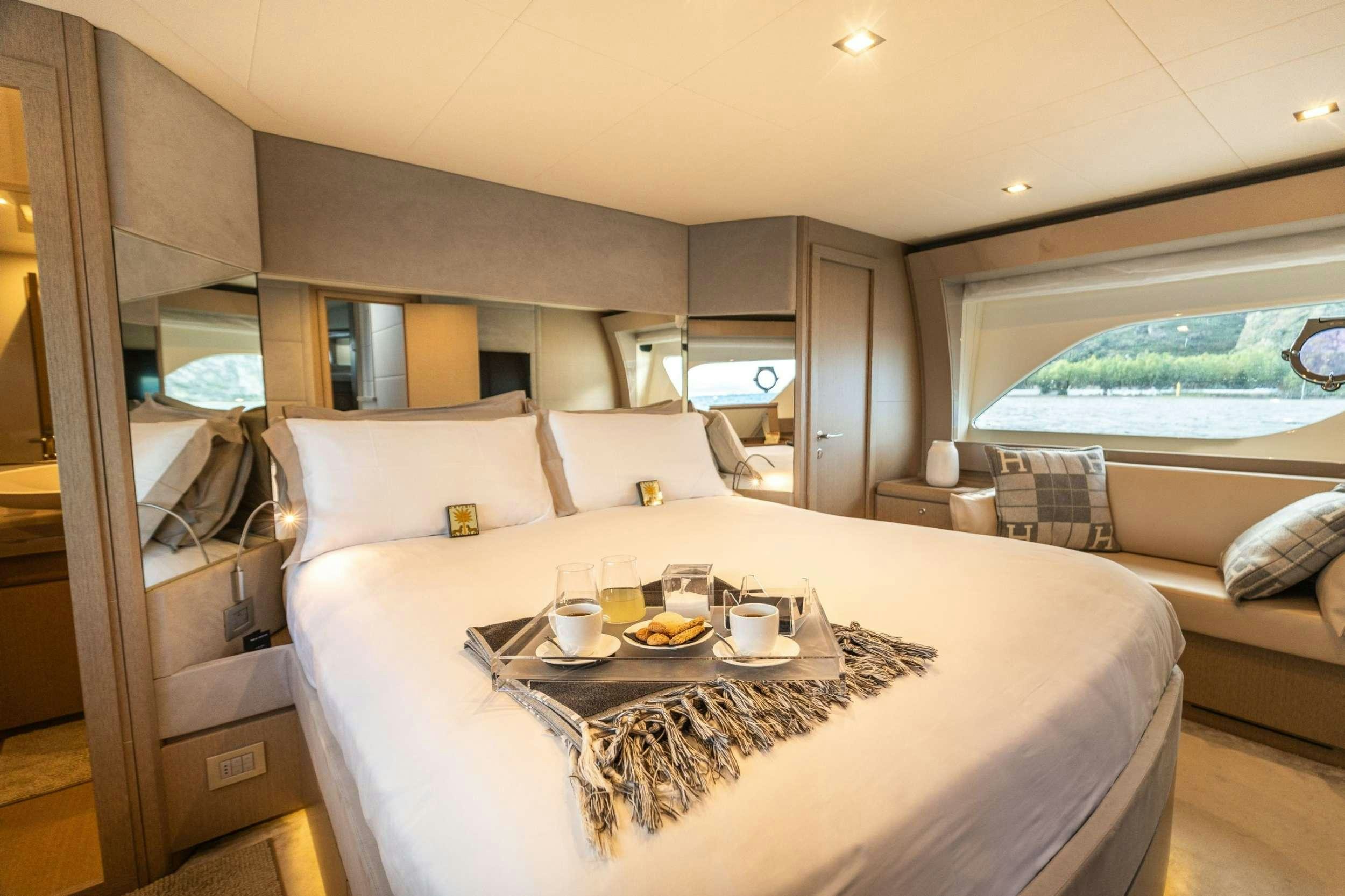 a room with a bed and a table with food on it aboard SEA SONS Yacht for Charter