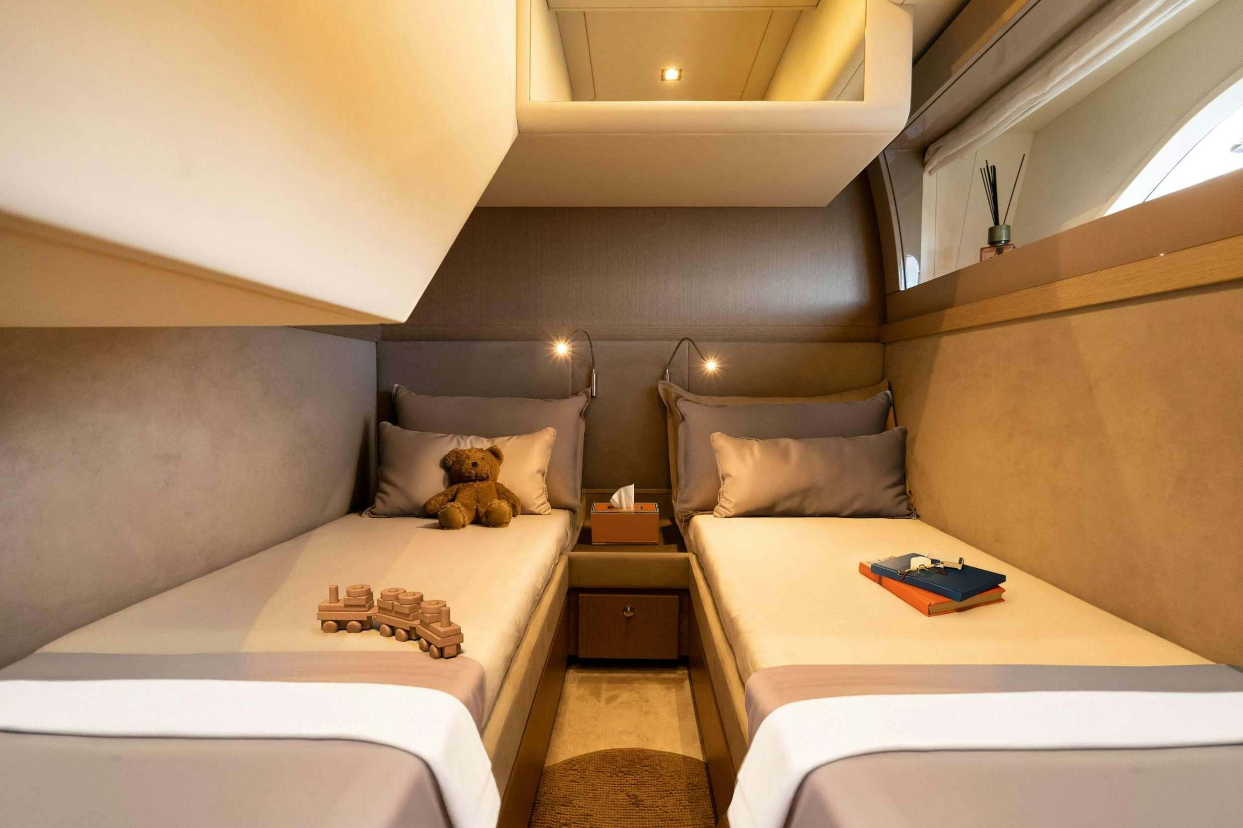 a bed with a white bed and a brown couch aboard SEA SONS Yacht for Charter