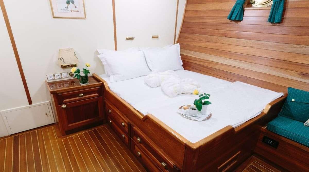 a bed with white sheets and pillows aboard SIR WINSTON CHURCHILL Yacht for Charter