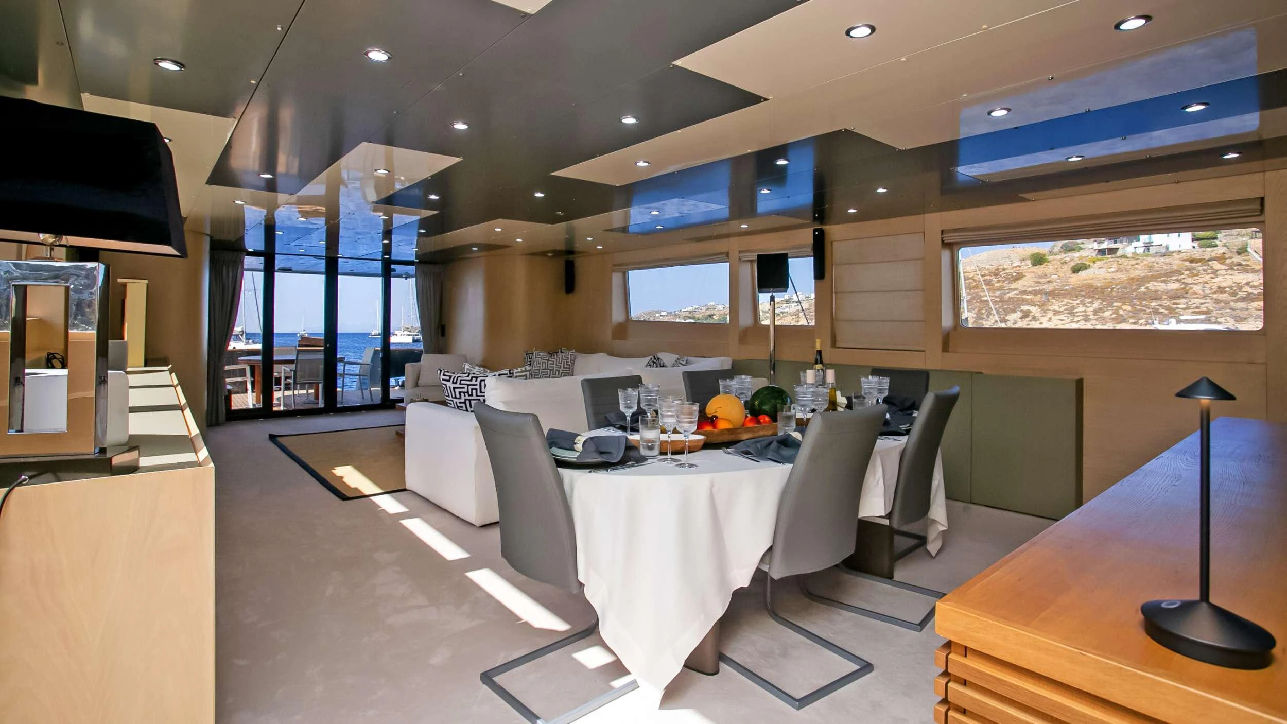 a large room with a table and chairs aboard MARAYA Yacht for Charter