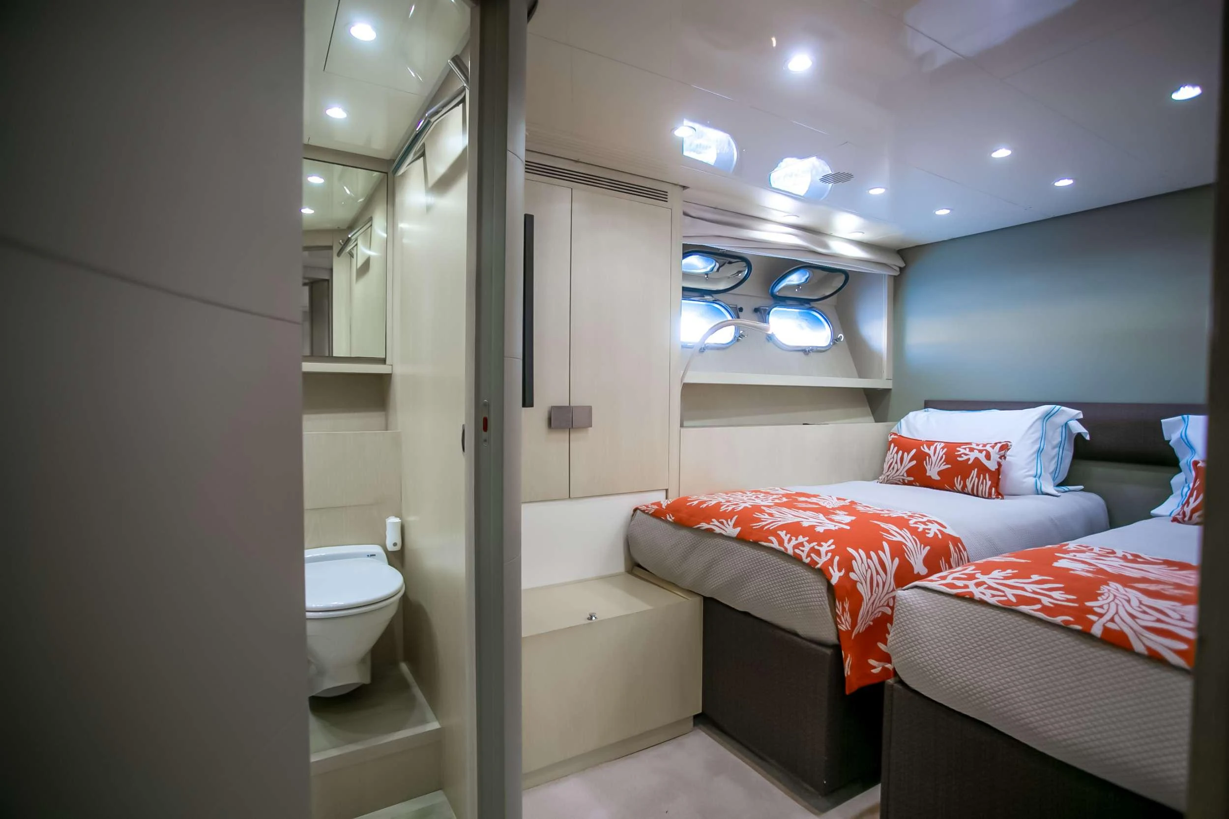 a bedroom with a bed and a mirror aboard MARAYA Yacht for Charter