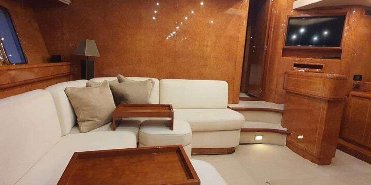 a living room with a couch and a tv aboard YALOOU DREAM Yacht for Charter