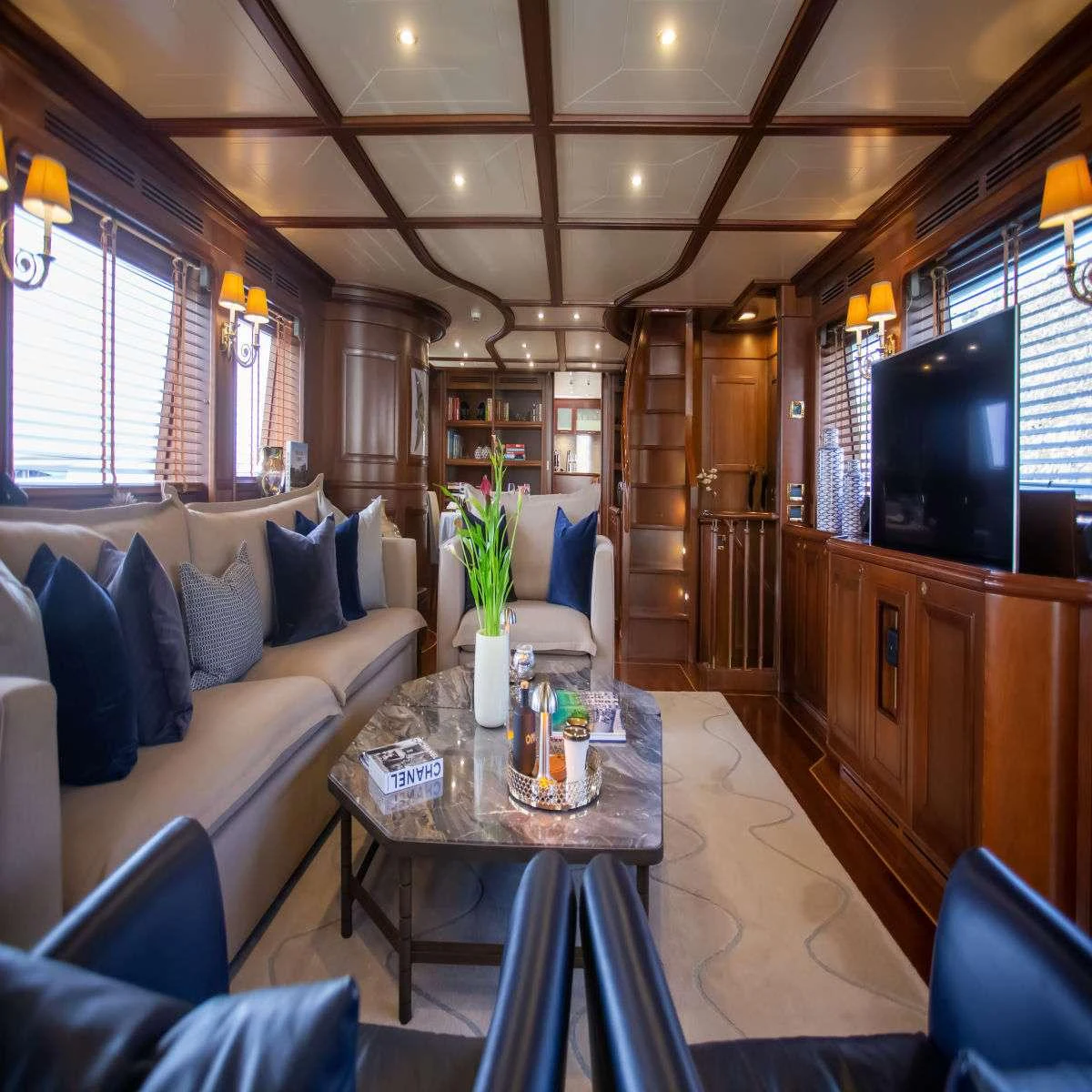 a living room with a large screen aboard HAG Yacht for Charter