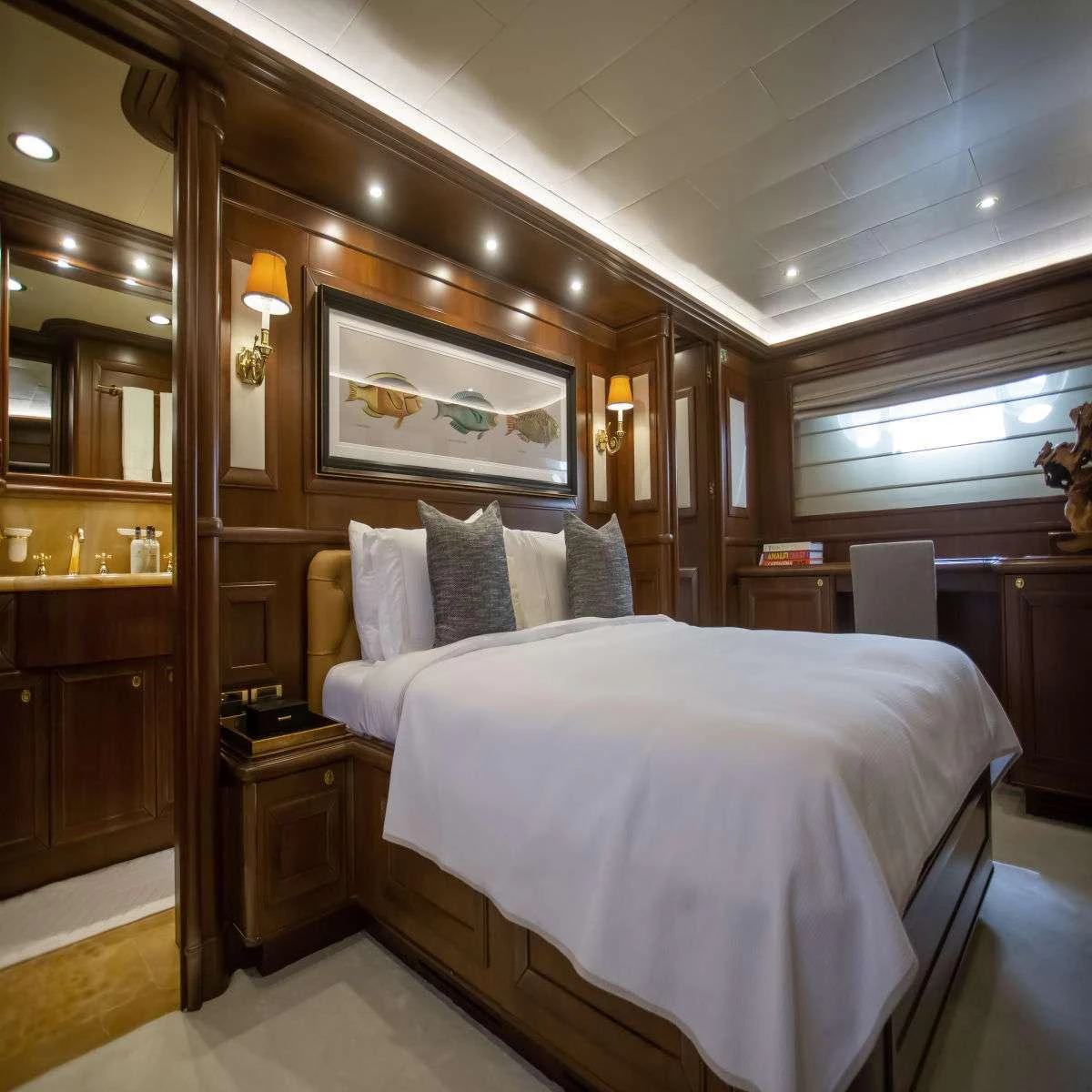 a bedroom with a large mirror aboard HAG Yacht for Charter