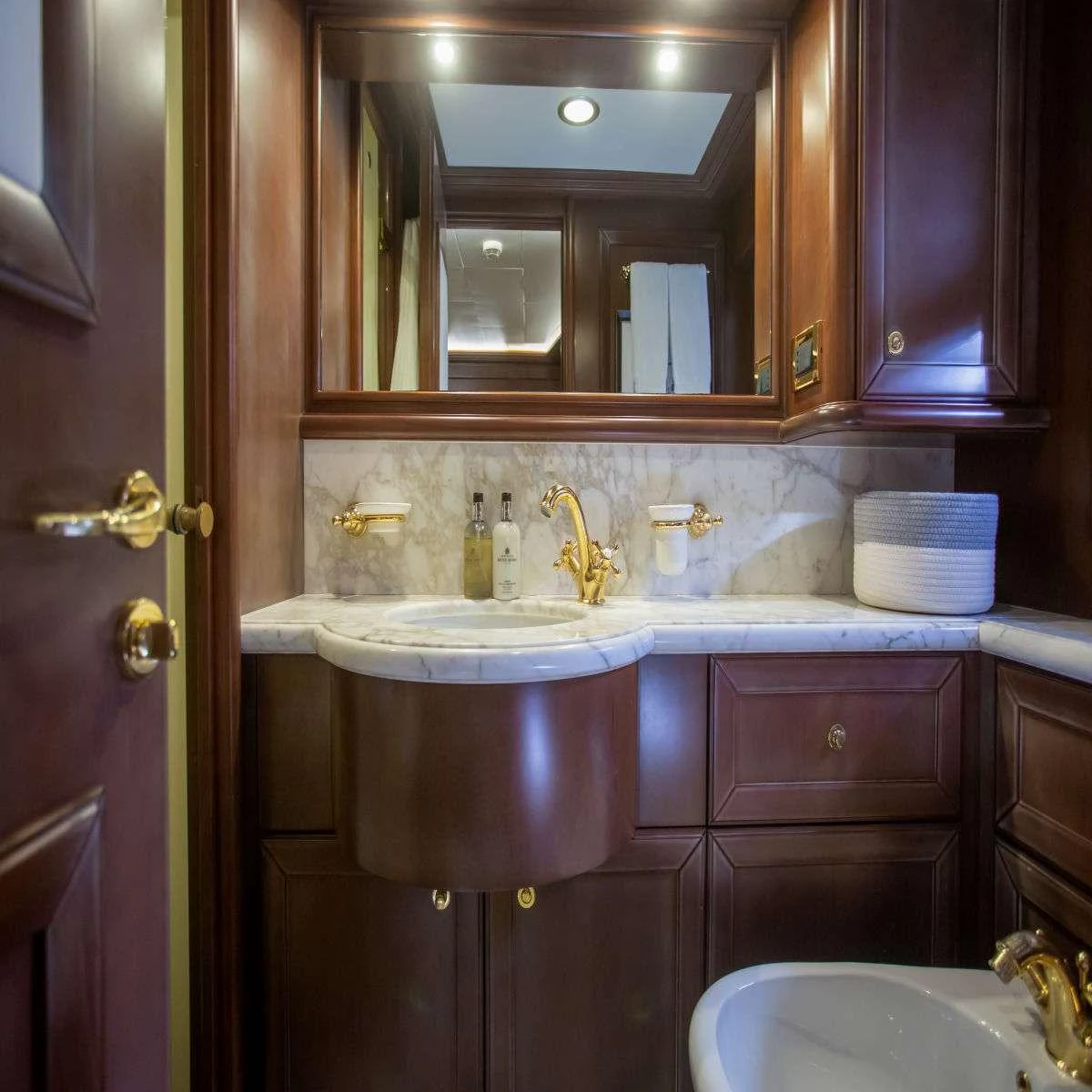 a bathroom with a sink and a mirror aboard HAG Yacht for Charter