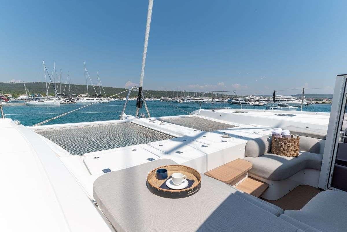 a deck with a boat and a steering wheel on it aboard SEADUCTIVE ORCA Yacht for Charter