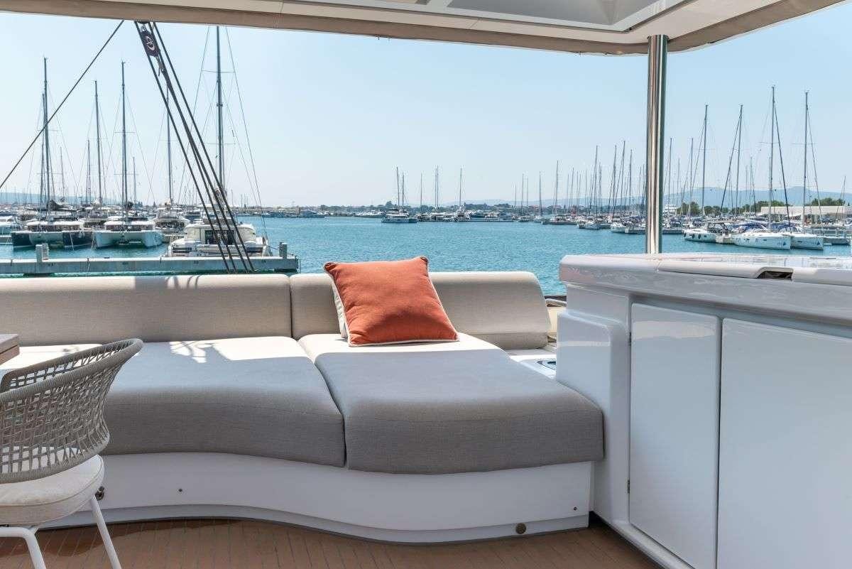 a couch and chairs on a boat aboard SEADUCTIVE ORCA Yacht for Charter