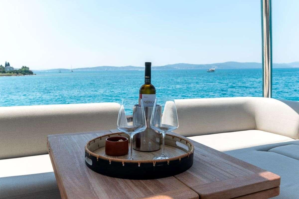 a bottle of wine on a table aboard SEADUCTIVE ORCA Yacht for Charter