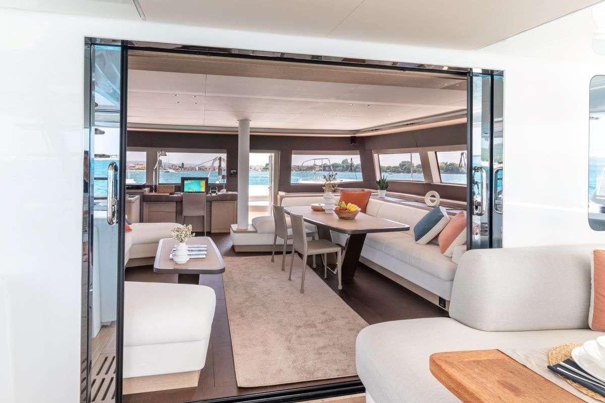 a living room with a large window aboard SEADUCTIVE ORCA Yacht for Charter