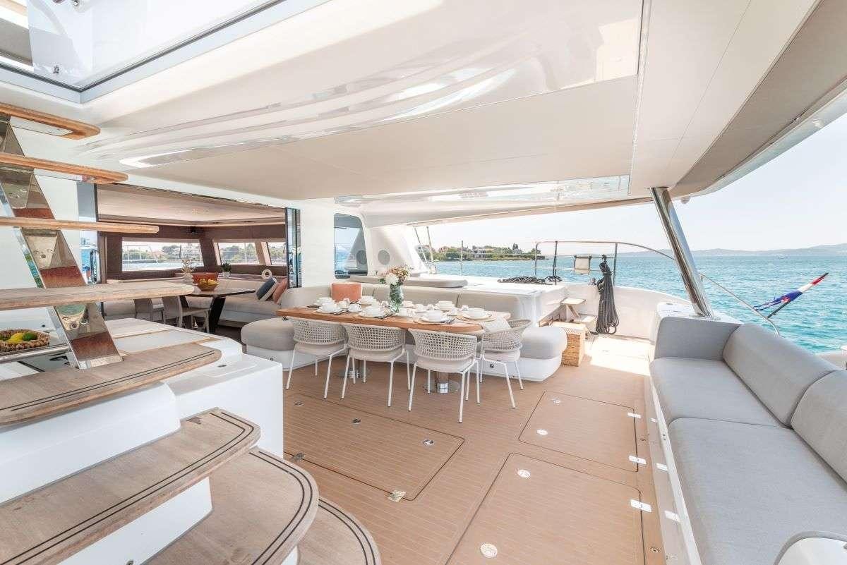 a room with a table and chairs aboard SEADUCTIVE ORCA Yacht for Charter