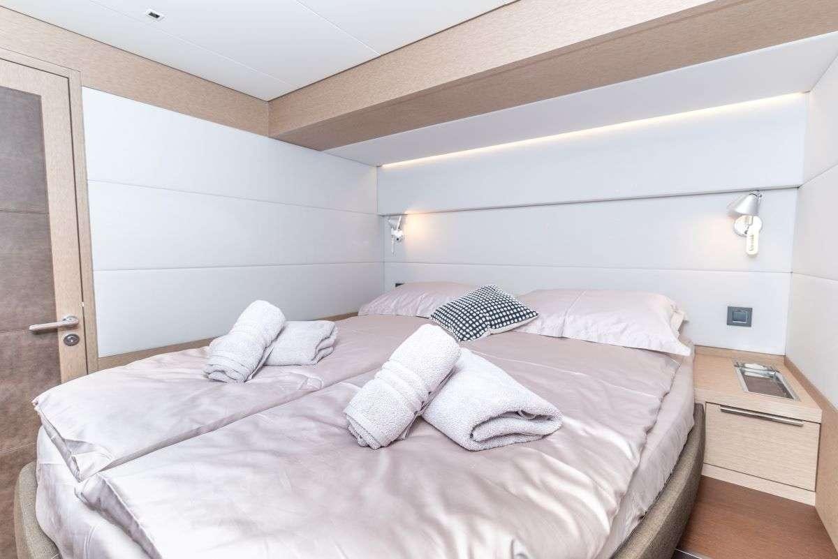 a bed with white sheets aboard SEADUCTIVE ORCA Yacht for Charter