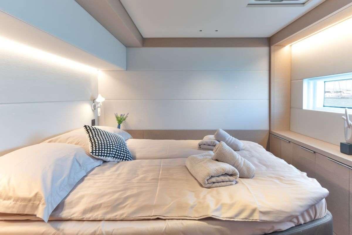 a bed with pillows aboard SEADUCTIVE ORCA Yacht for Charter