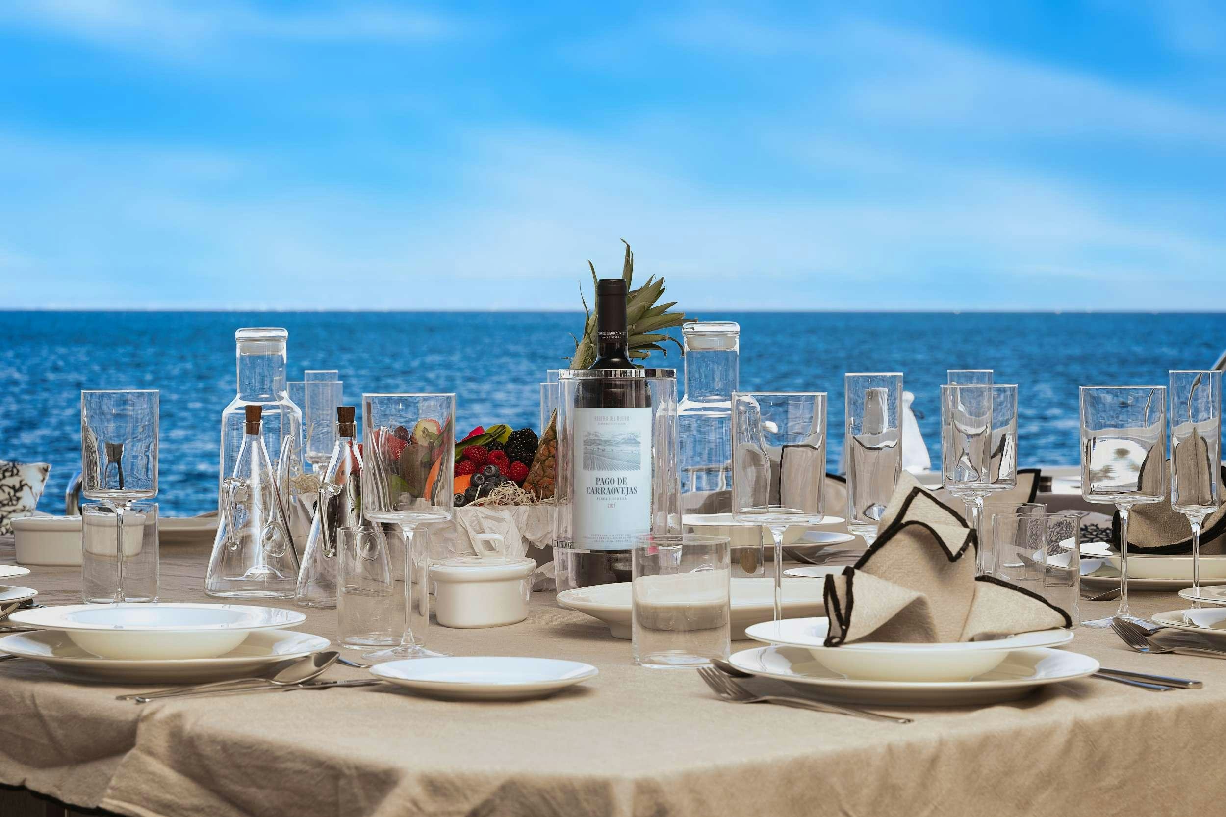 a table with wine glasses and bottles aboard ERA Yacht for Charter