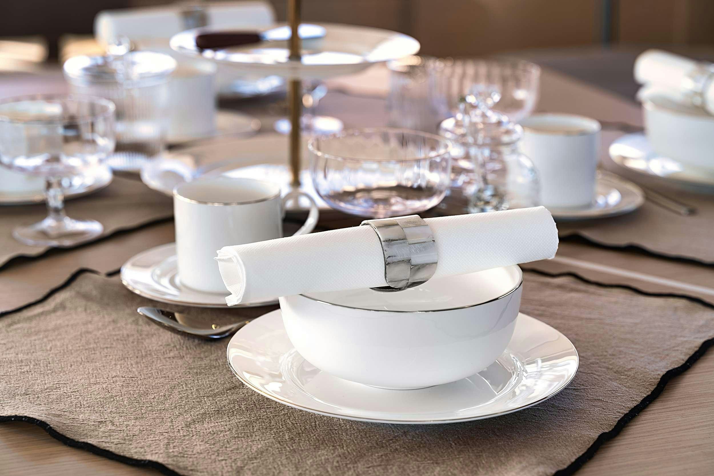 a white plate with a spoon and a plate with cups on it aboard ERA Yacht for Charter