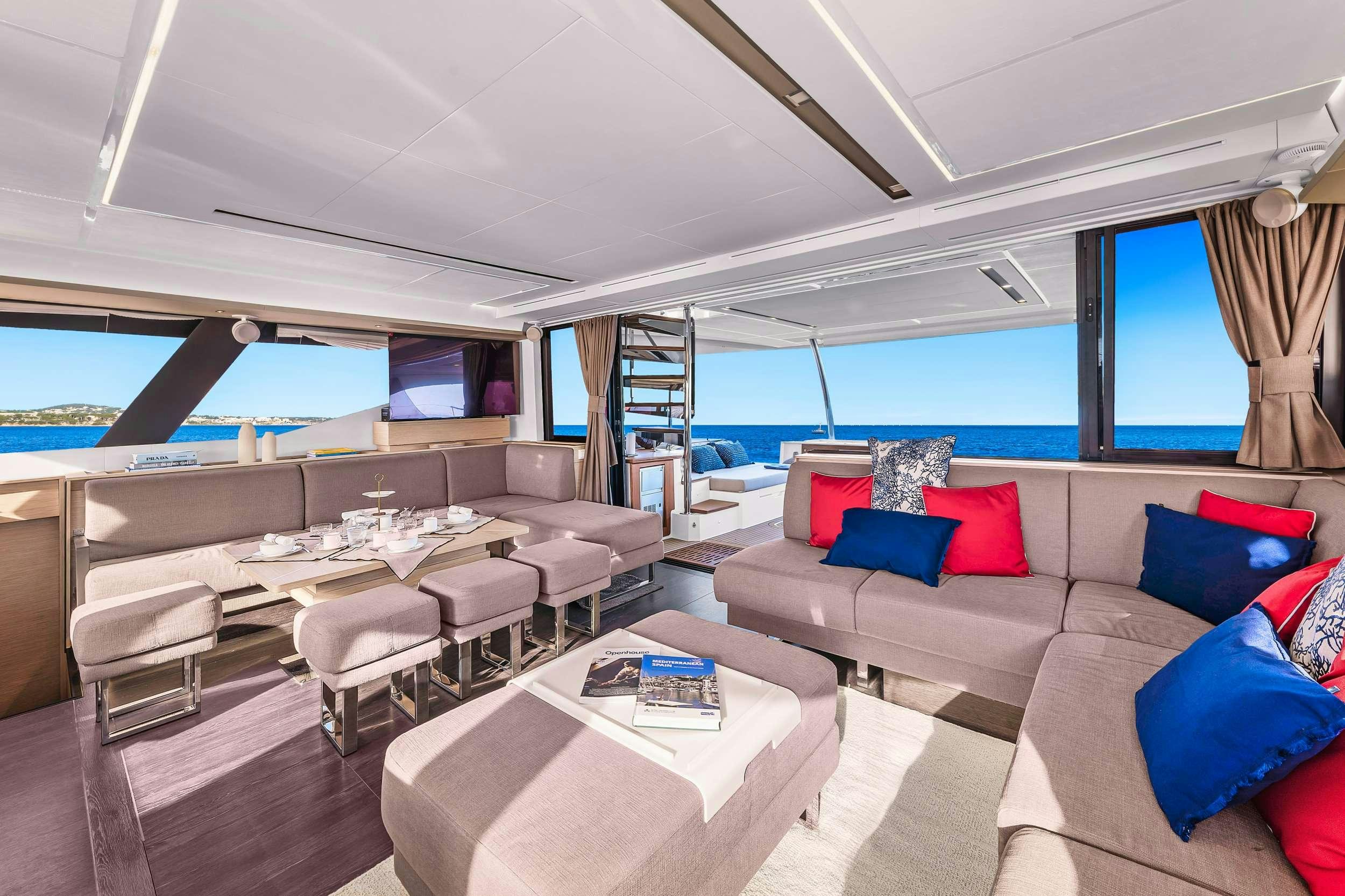 a living room with a large window aboard ERA Yacht for Charter