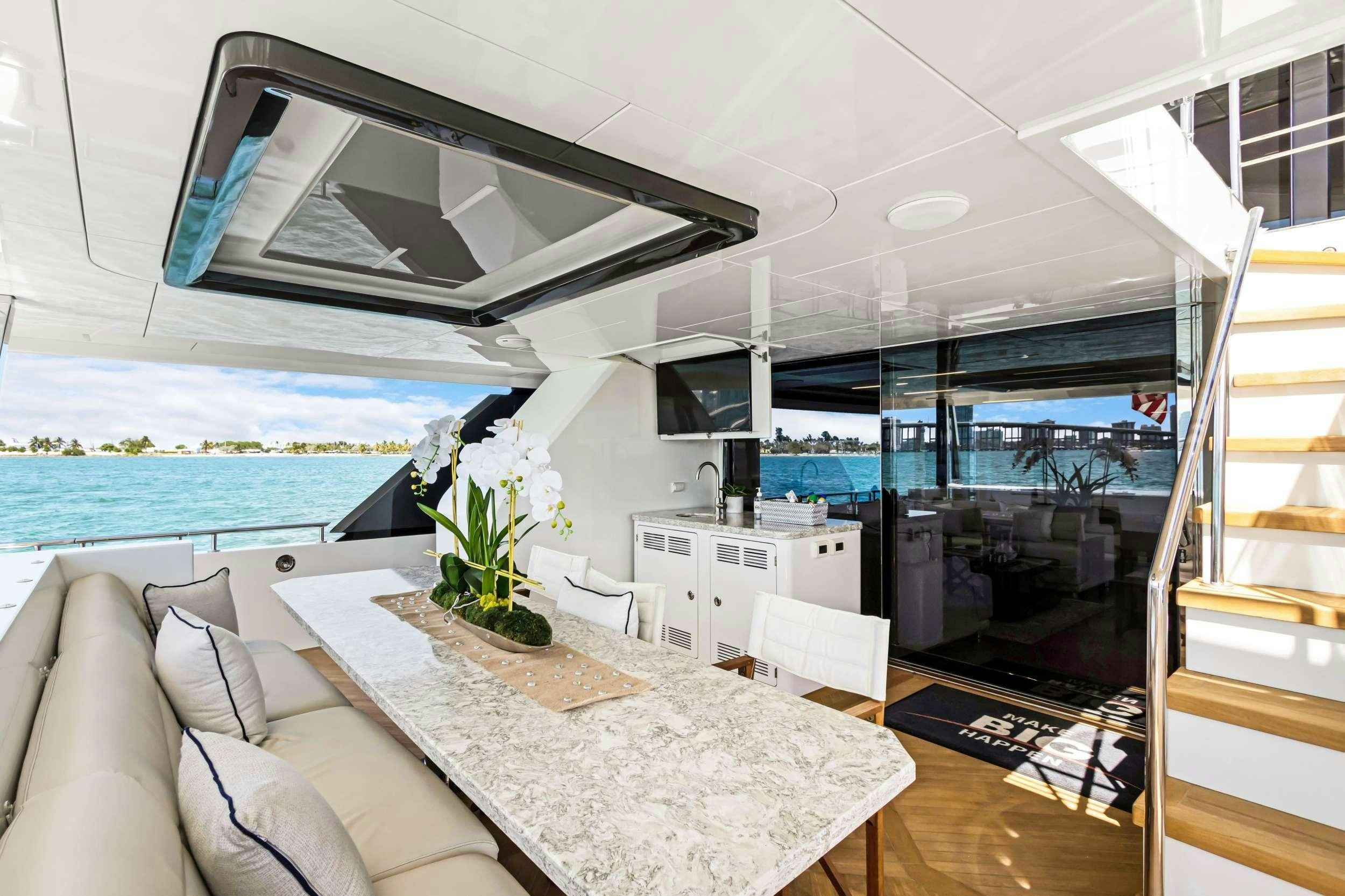 a living room with a large window aboard MAKE BIG HAPPEN Yacht for Charter