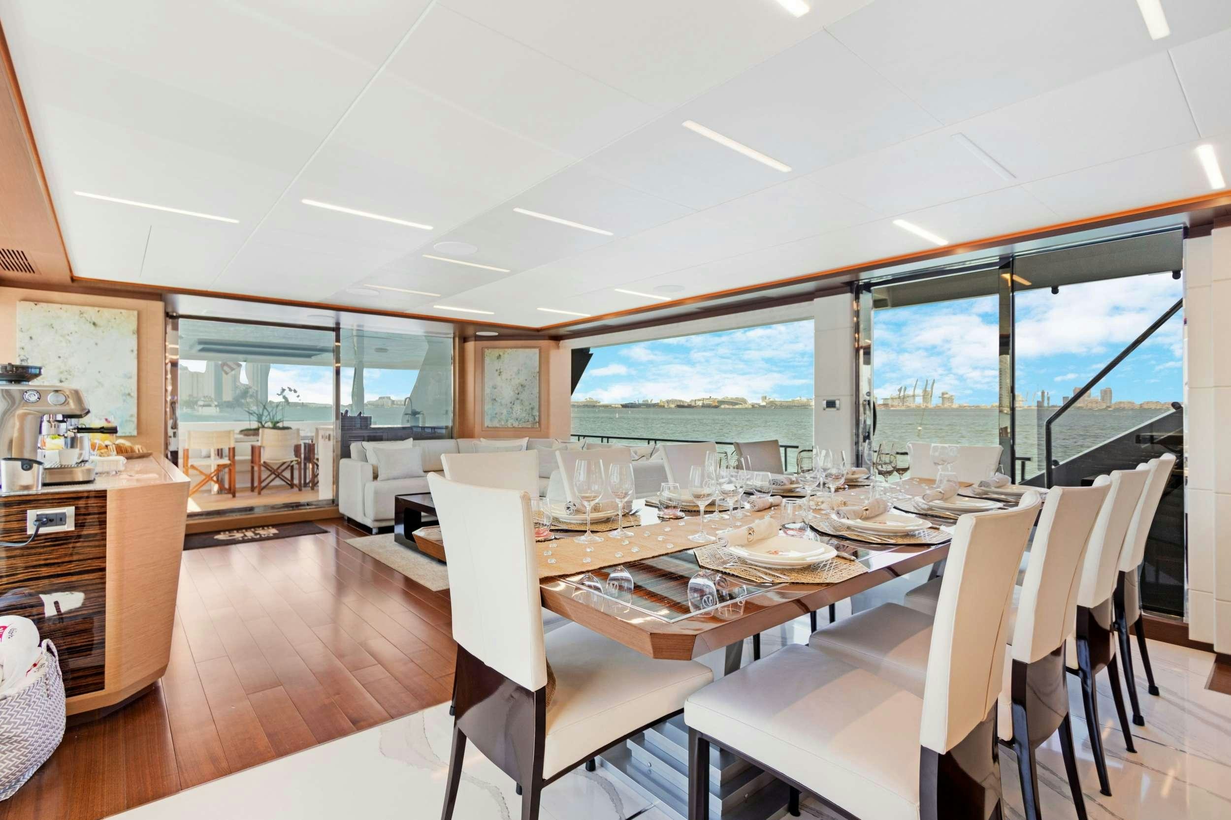 a dining room with a large window aboard MAKE BIG HAPPEN Yacht for Charter