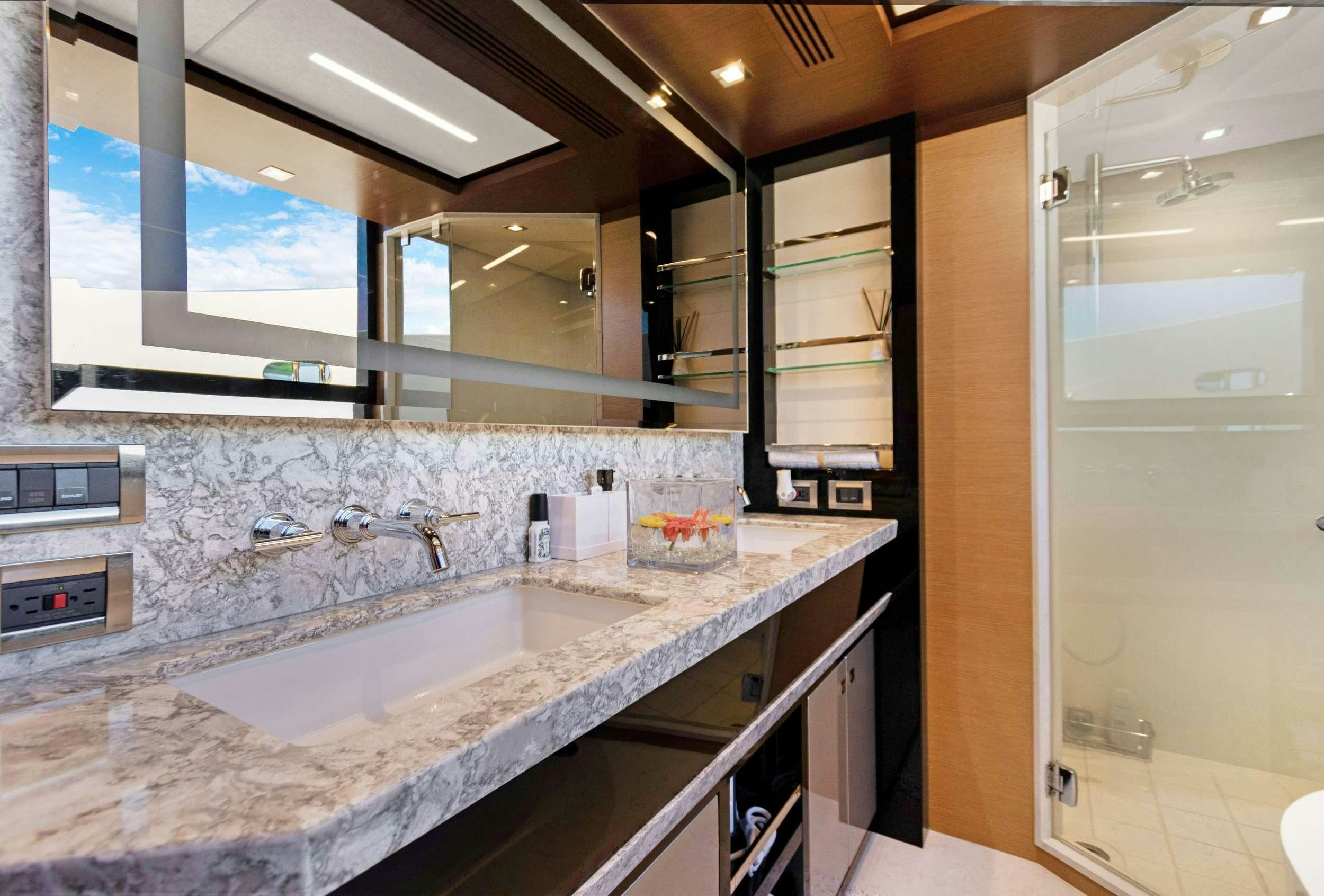 a bathroom with a large mirror aboard MAKE BIG HAPPEN Yacht for Charter