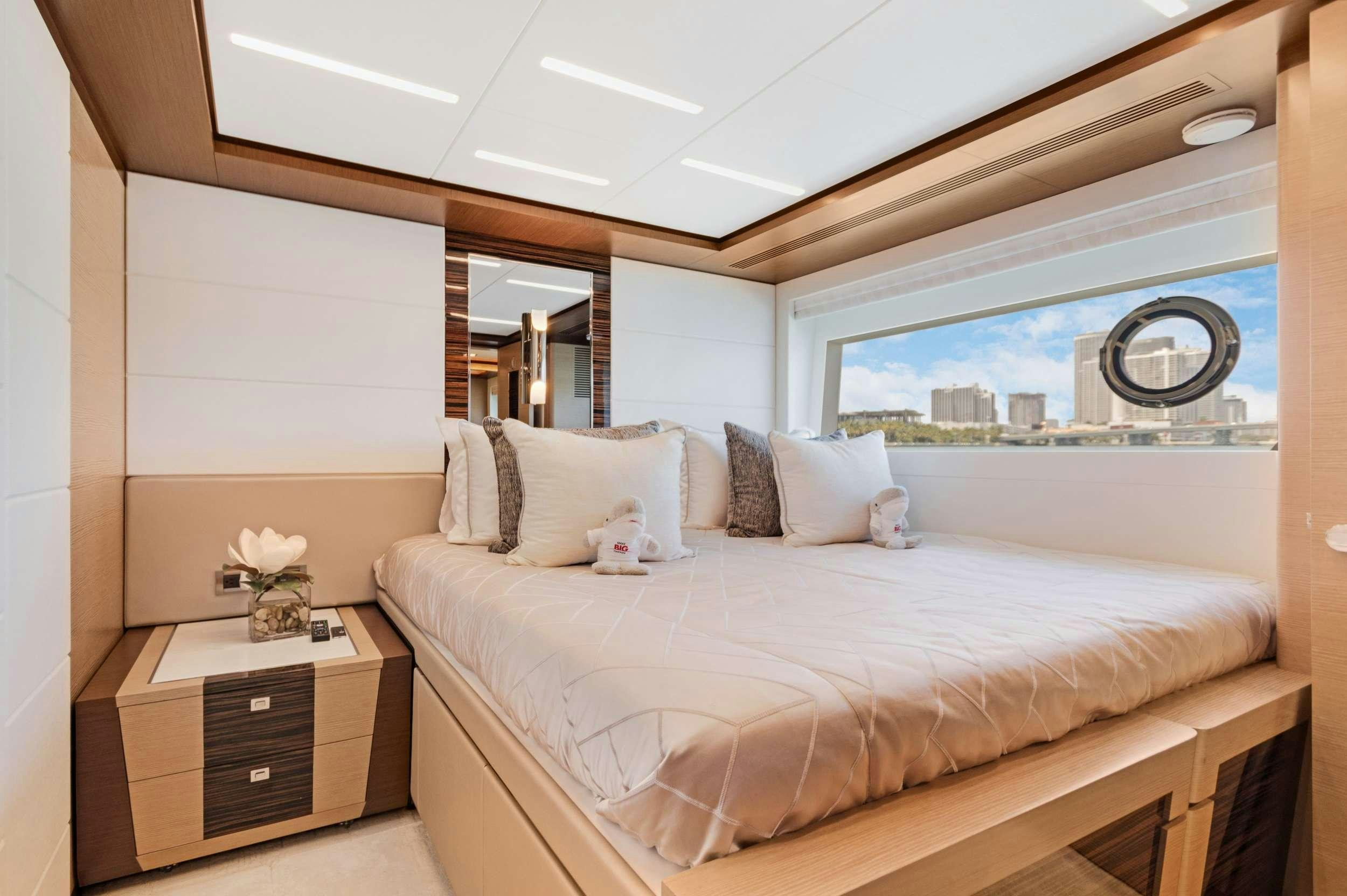 a bedroom with a large bed aboard MAKE BIG HAPPEN Yacht for Charter