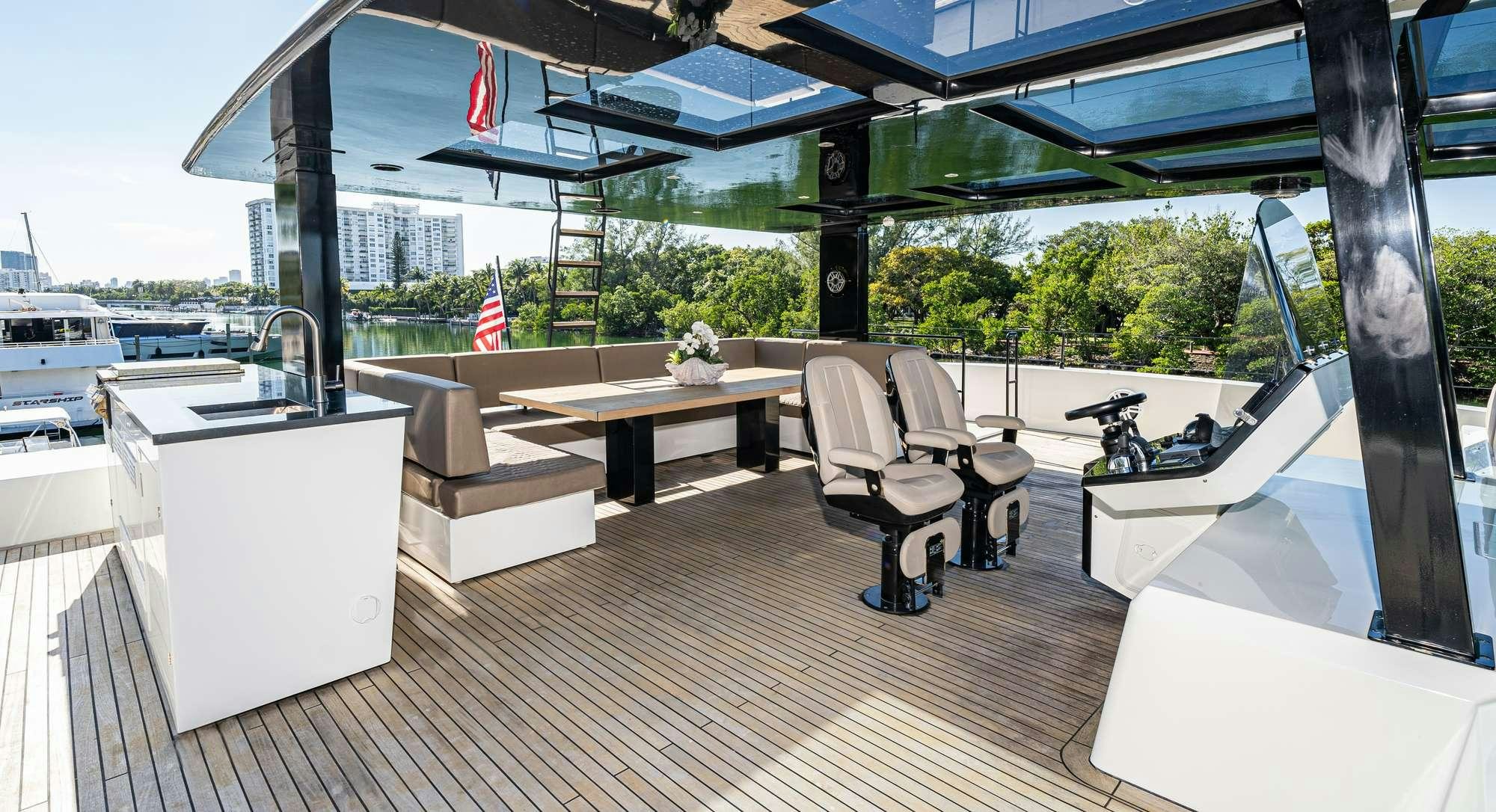 a room with a table chairs and a bench aboard ROCK STAR 2.0 Yacht for Charter