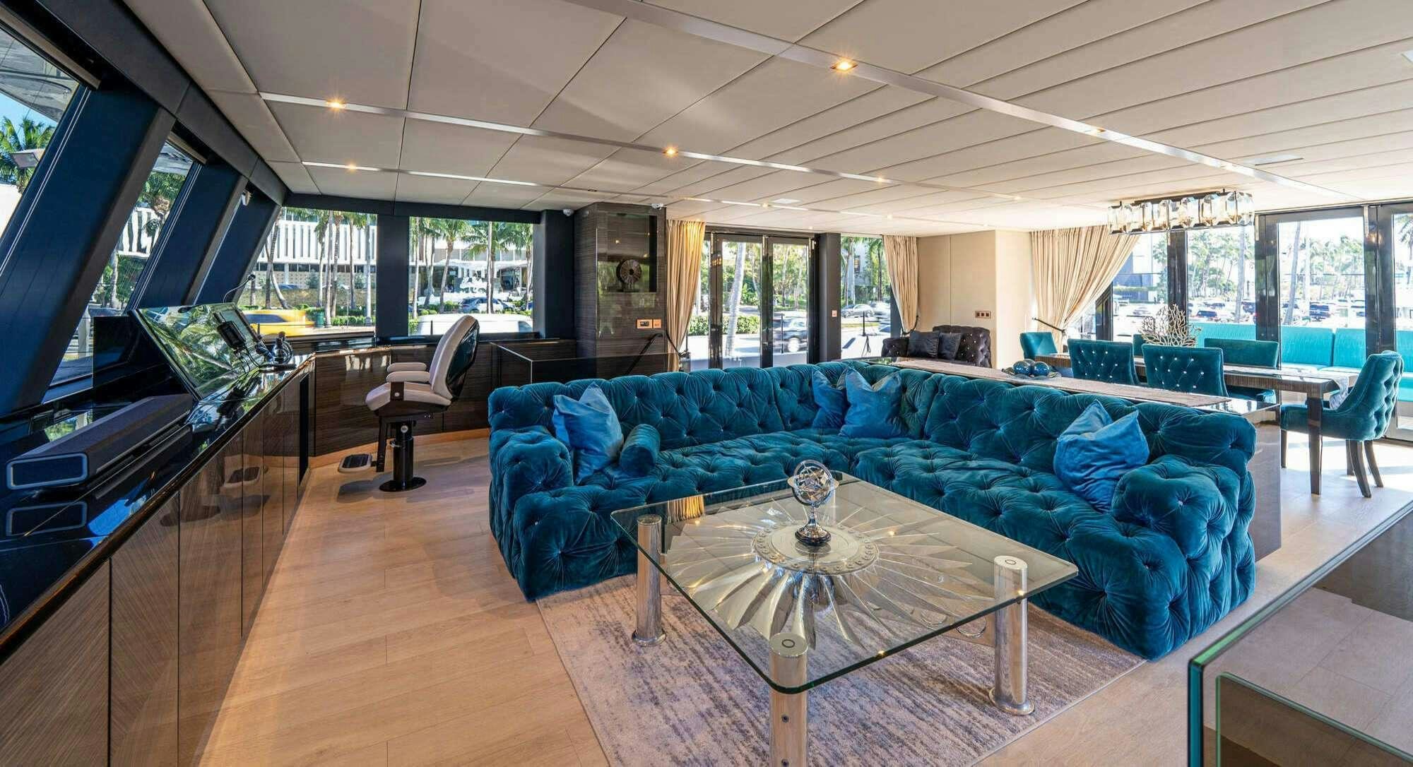 a living room with a blue couch aboard ROCK STAR 2.0 Yacht for Charter