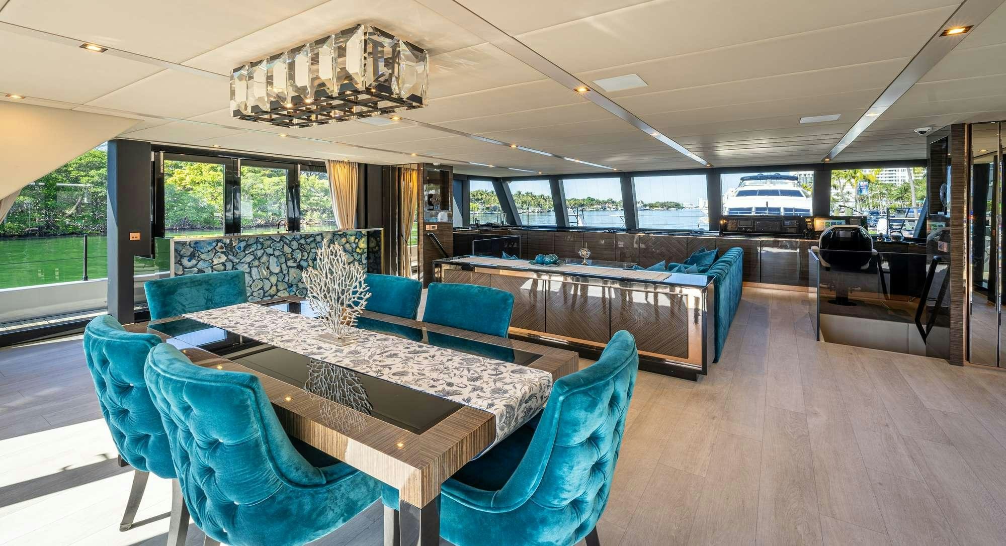 a large room with a pool table and chairs aboard ROCK STAR 2.0 Yacht for Charter