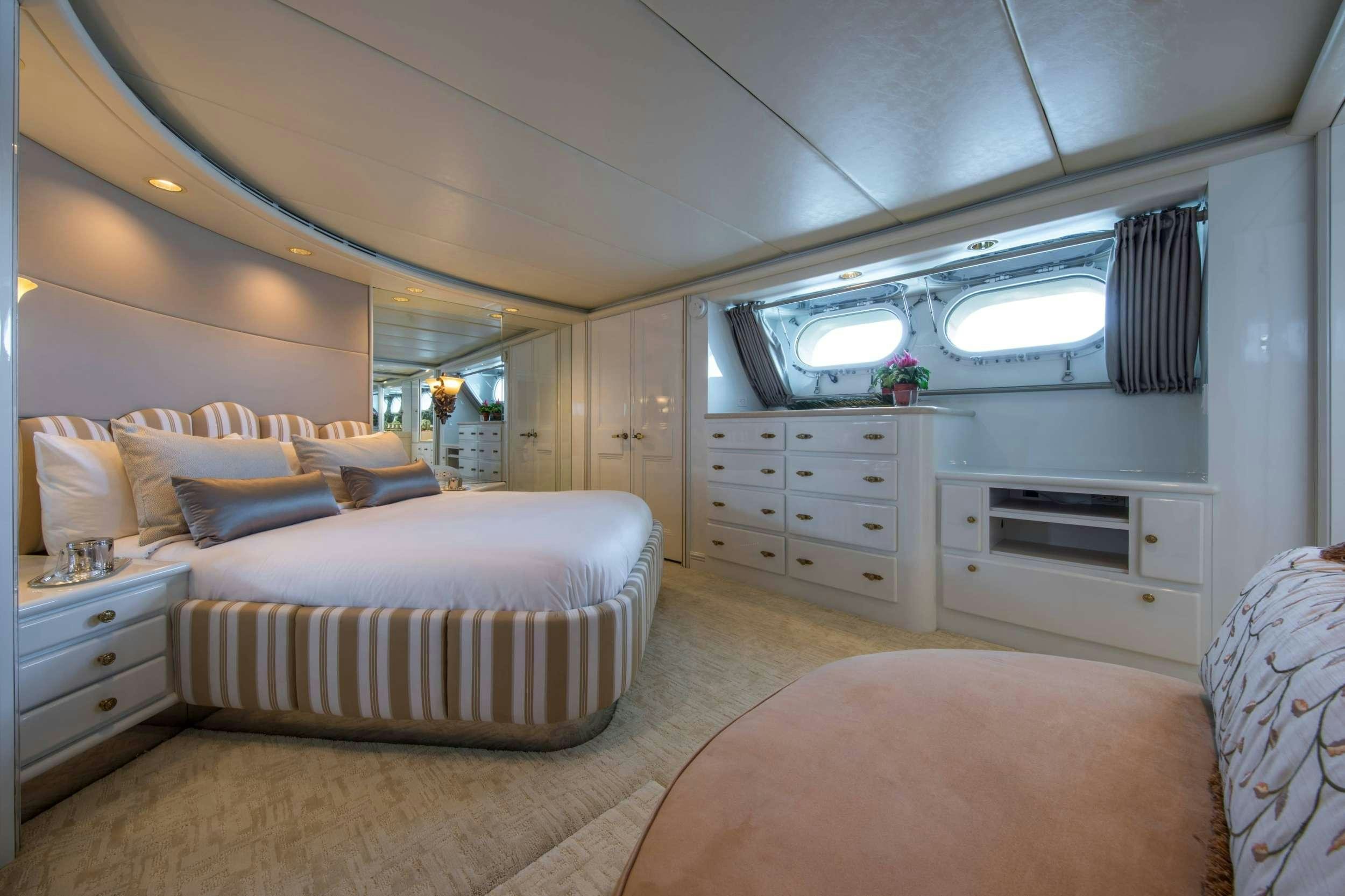 a bedroom with a bed and a tv aboard GRACE Yacht for Charter