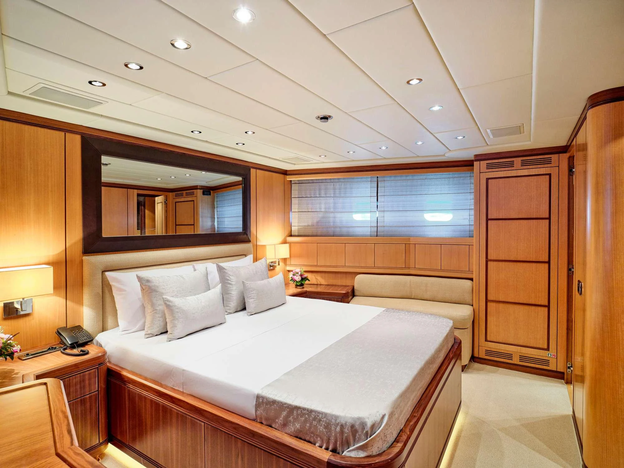 a room with a bed and a desk aboard WET PANTHER Yacht for Charter