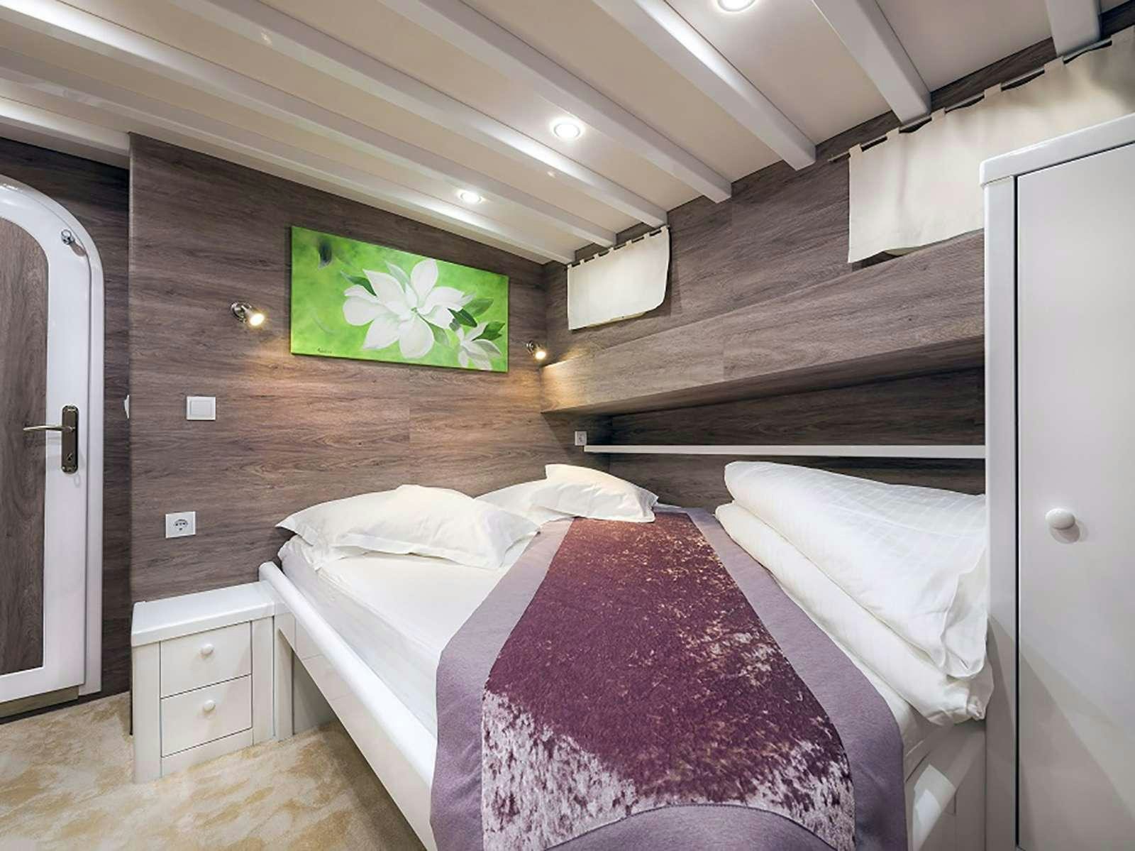 a couple of beds in a cabin aboard ANĐEO Yacht for Charter