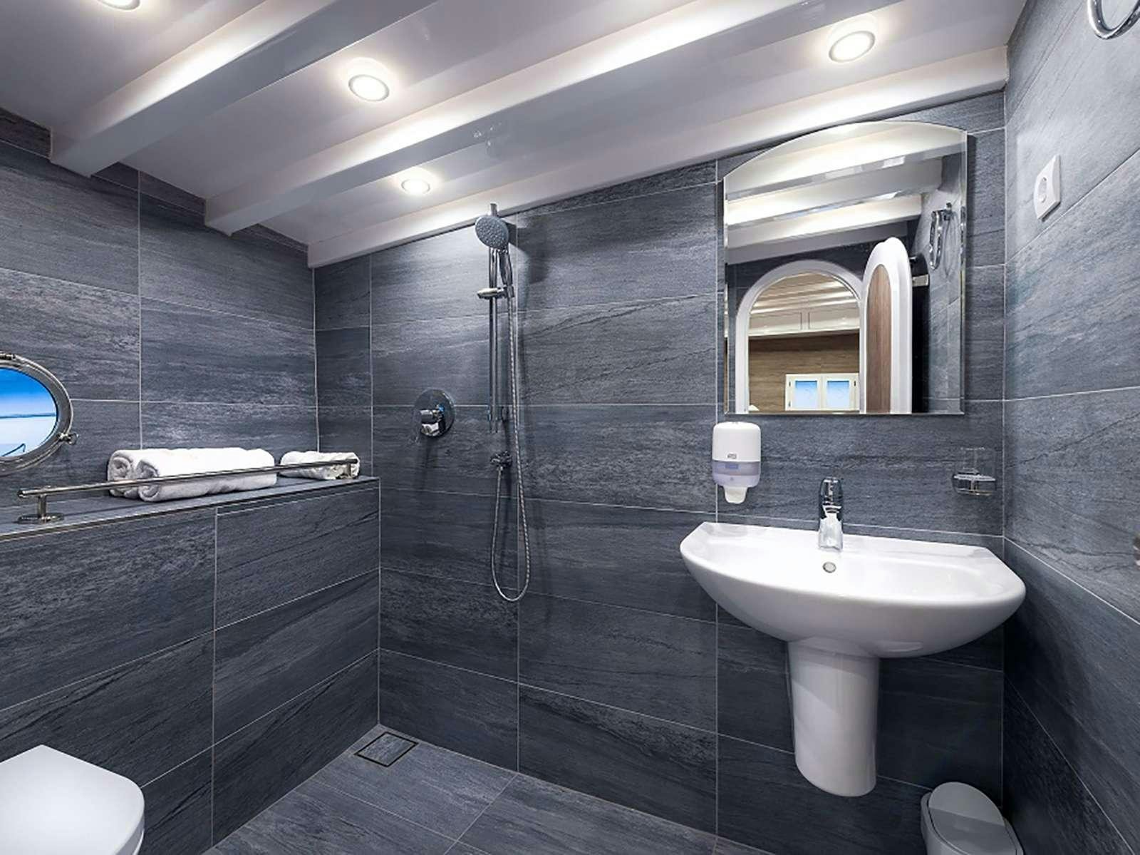 a bathroom with a large mirror aboard ANĐEO Yacht for Charter
