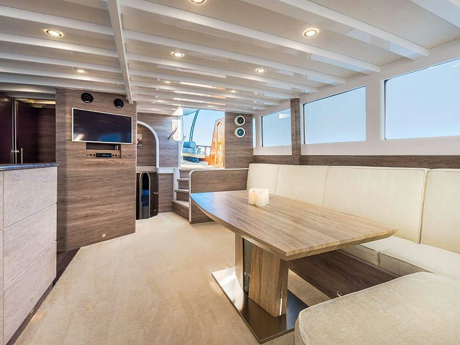 a room with a table and chairs aboard ANĐEO Yacht for Charter