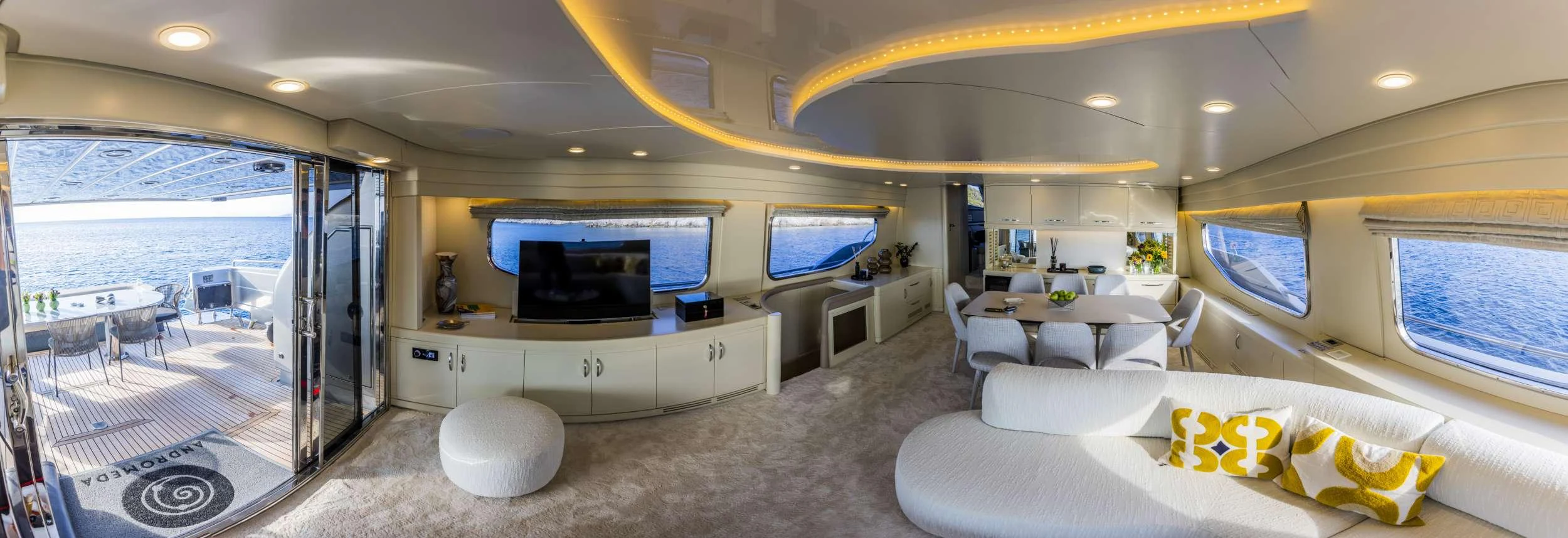 a large room with a couch and a tv aboard ANDROMEDA Yacht for Charter