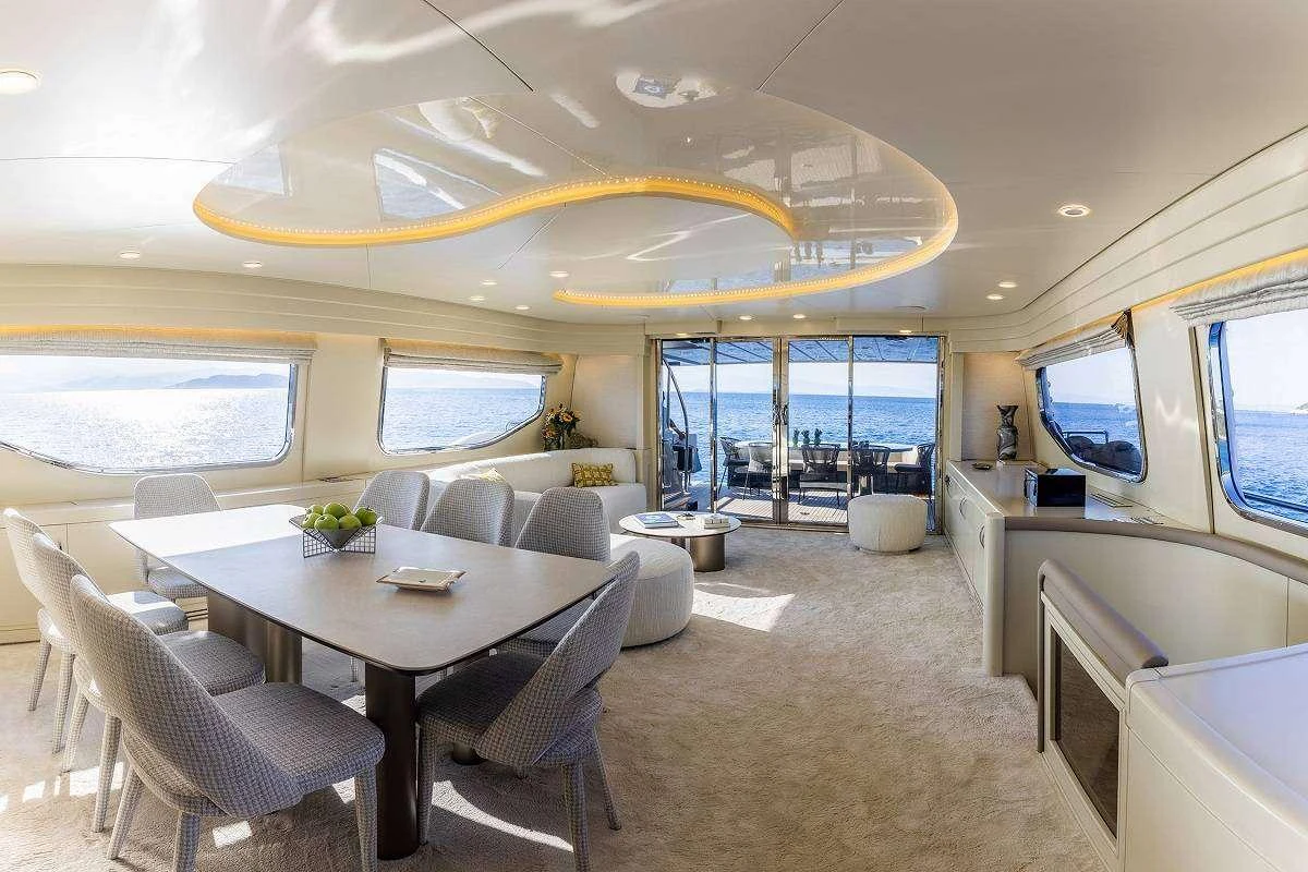 a large room with a table and chairs aboard ANDROMEDA Yacht for Charter