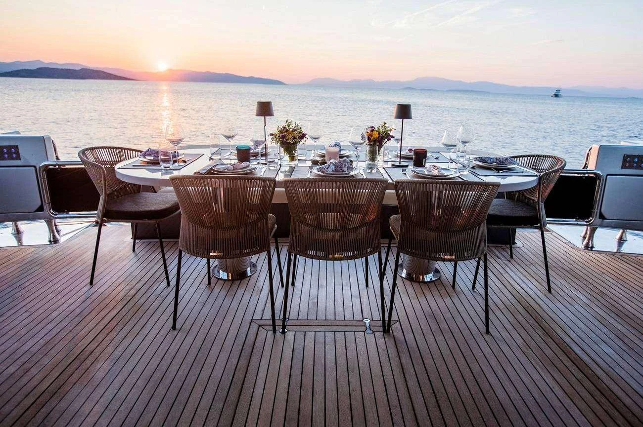 a table set for a dinner party aboard ANDROMEDA Yacht for Charter