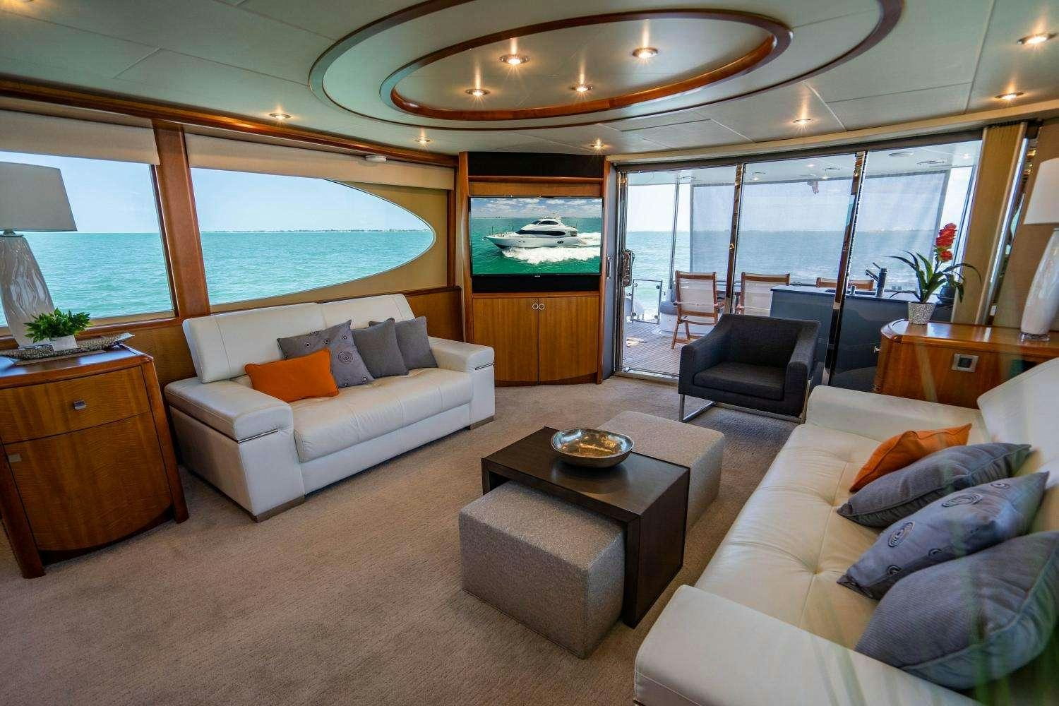 a living room with a large window aboard VOYAGER Yacht for Charter
