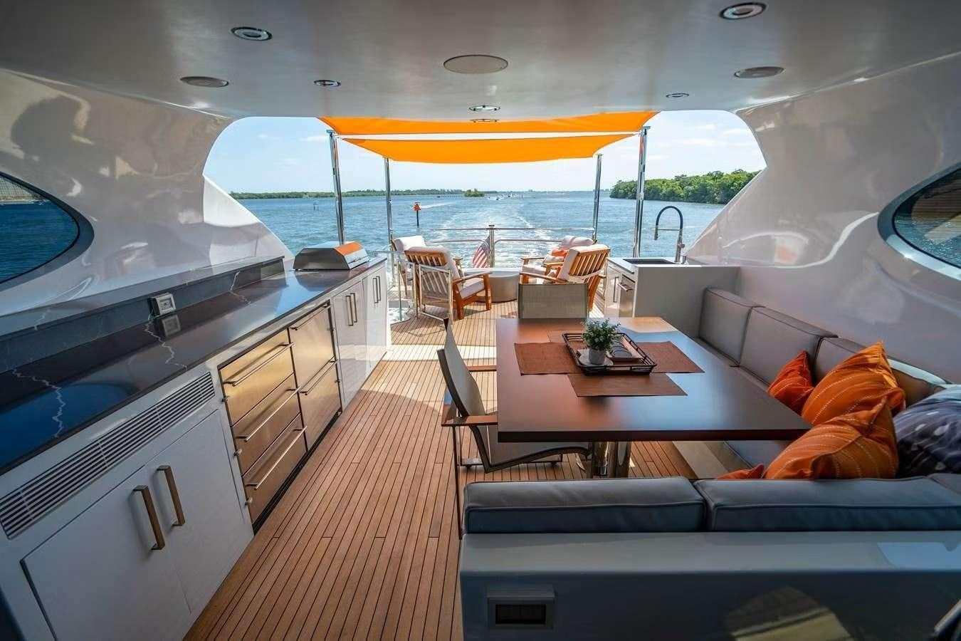 a boat with a table and chairs aboard VOYAGER Yacht for Charter