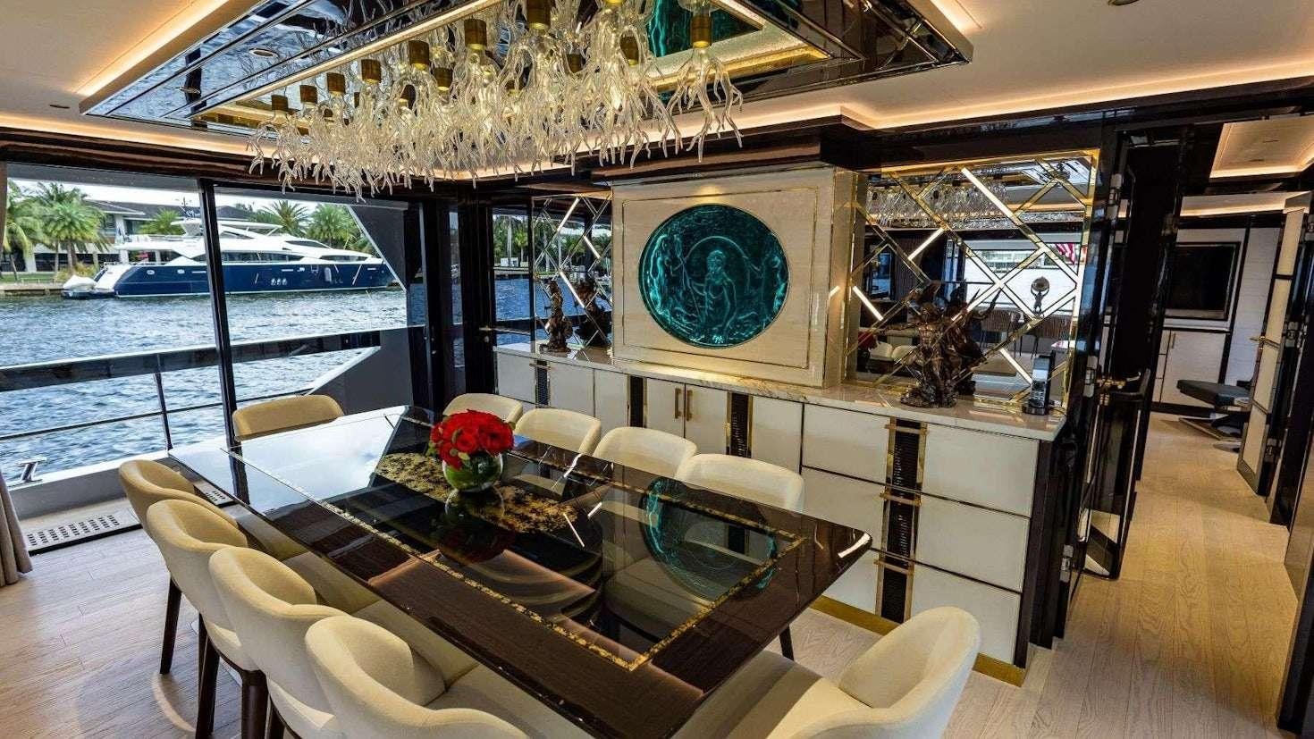 a dining room with a large window aboard OLYMPUS Yacht for Charter