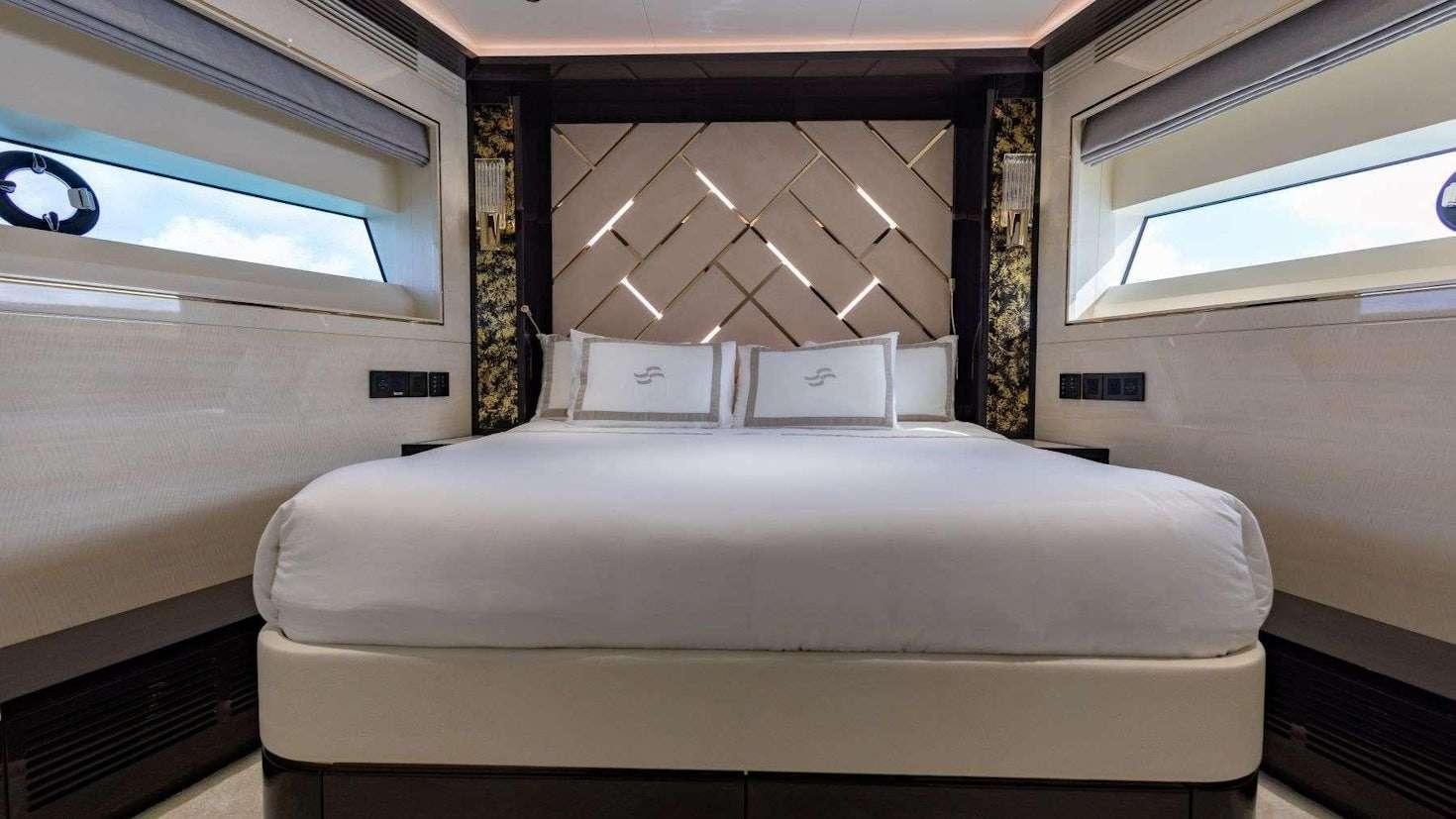 a bed in a room aboard OLYMPUS Yacht for Charter