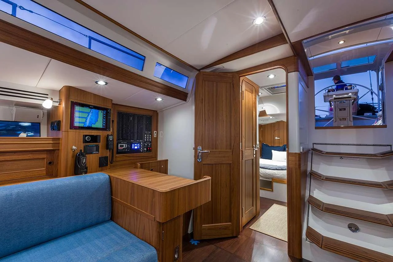 a room with a bed and a couch aboard CIRRUS Yacht for Charter
