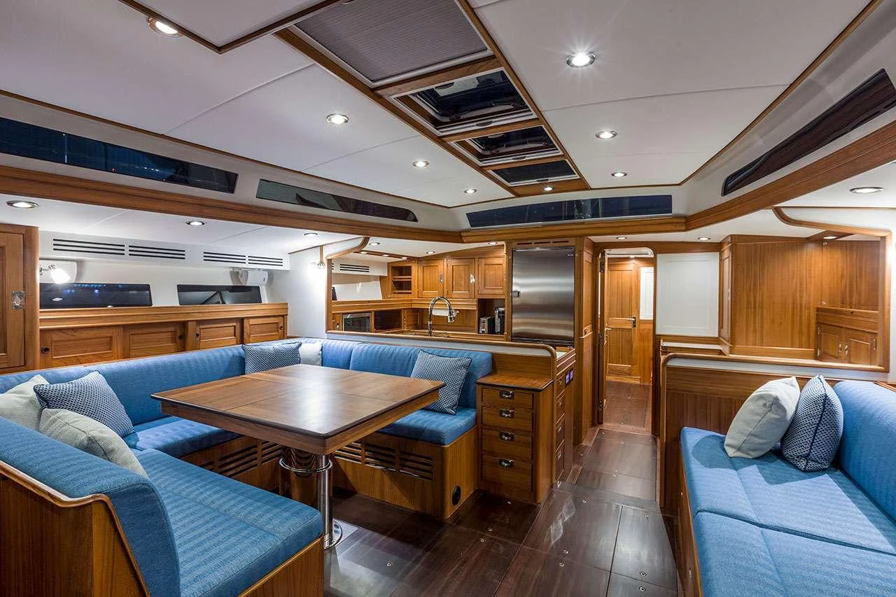 a living room with a table and couches aboard CIRRUS Yacht for Charter