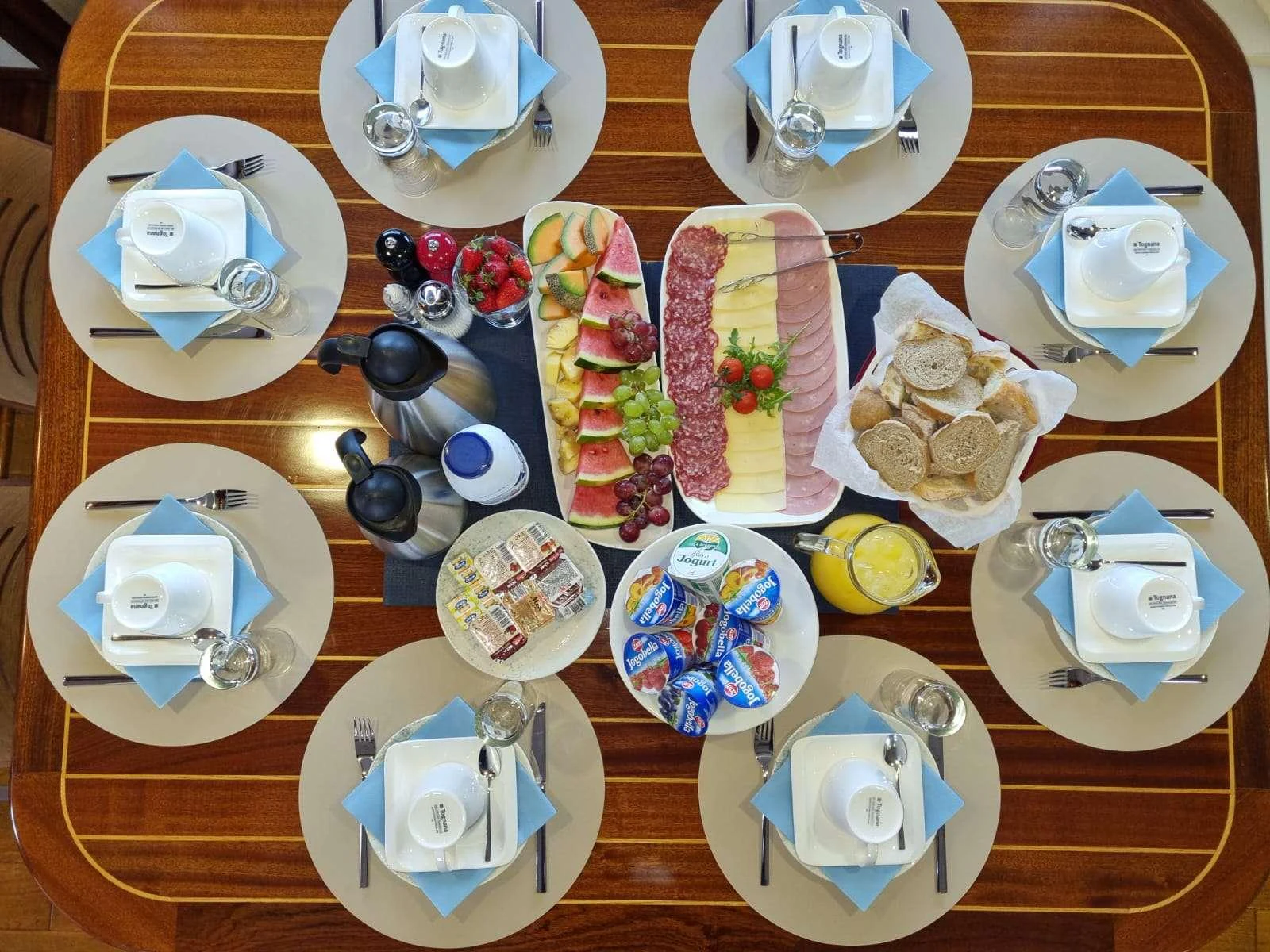 a table with plates and silverware aboard MENDULA Yacht for Charter