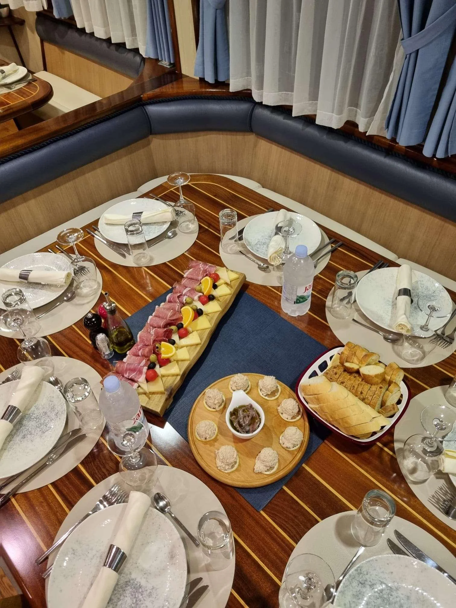 a table with plates and silverware aboard MENDULA Yacht for Charter