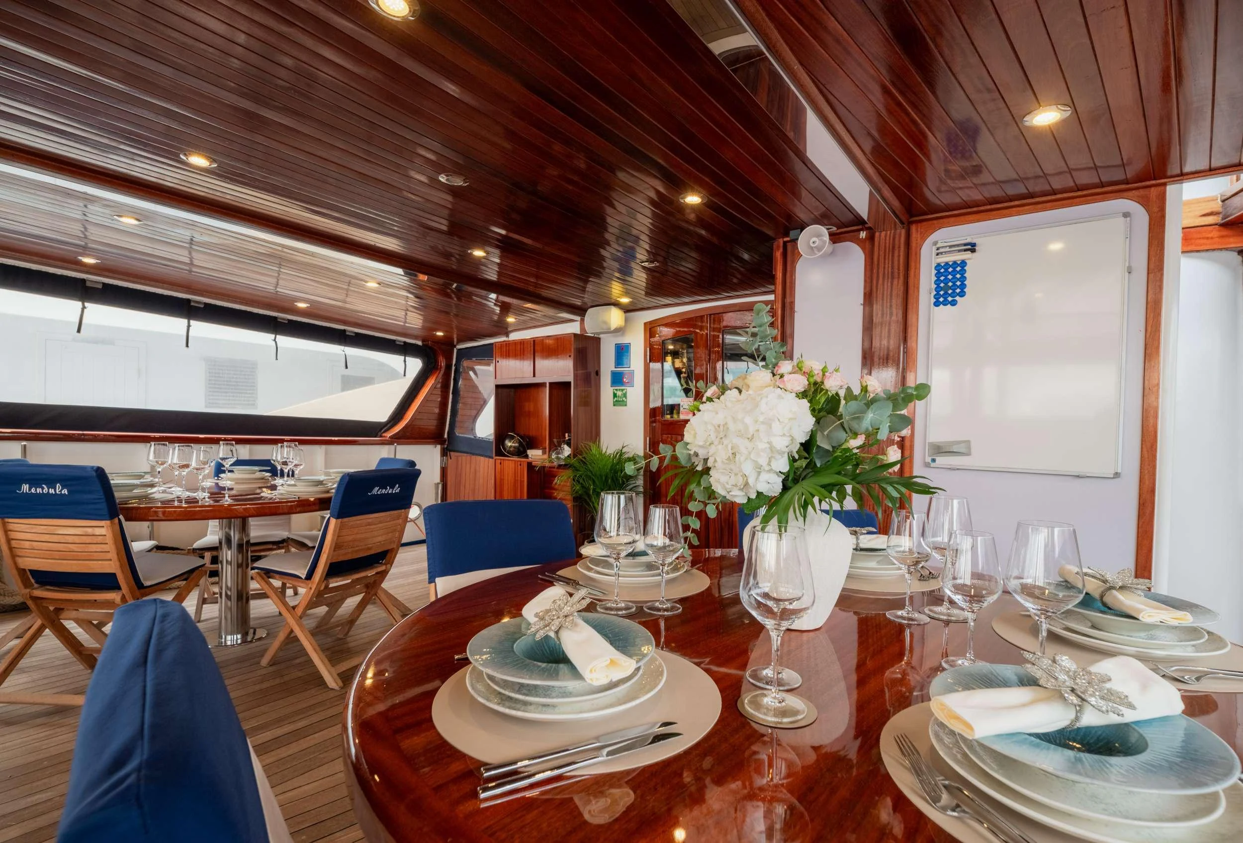 a dining room with a table set aboard MENDULA Yacht for Charter