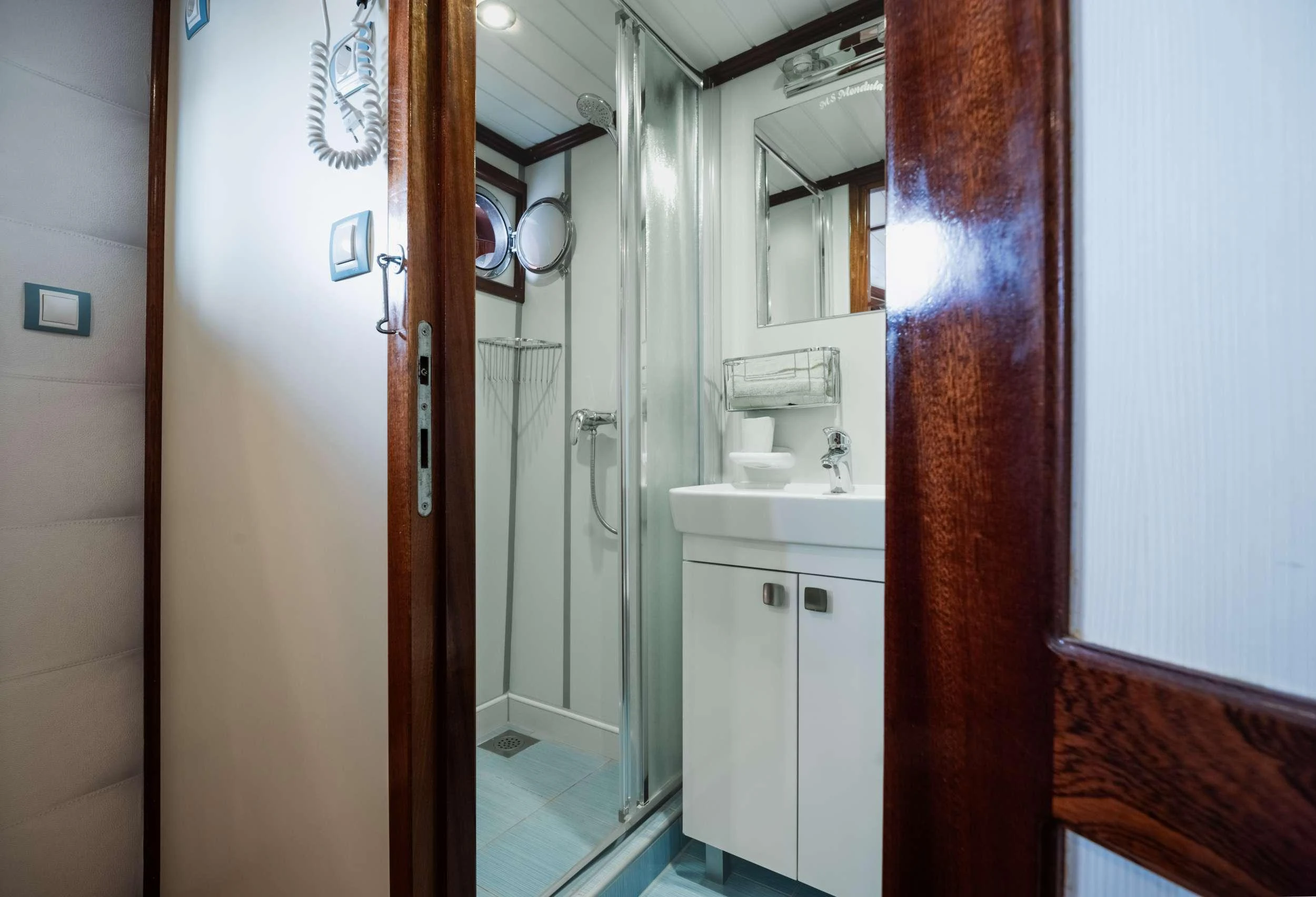 a bathroom with a sink and a mirror aboard MENDULA Yacht for Charter