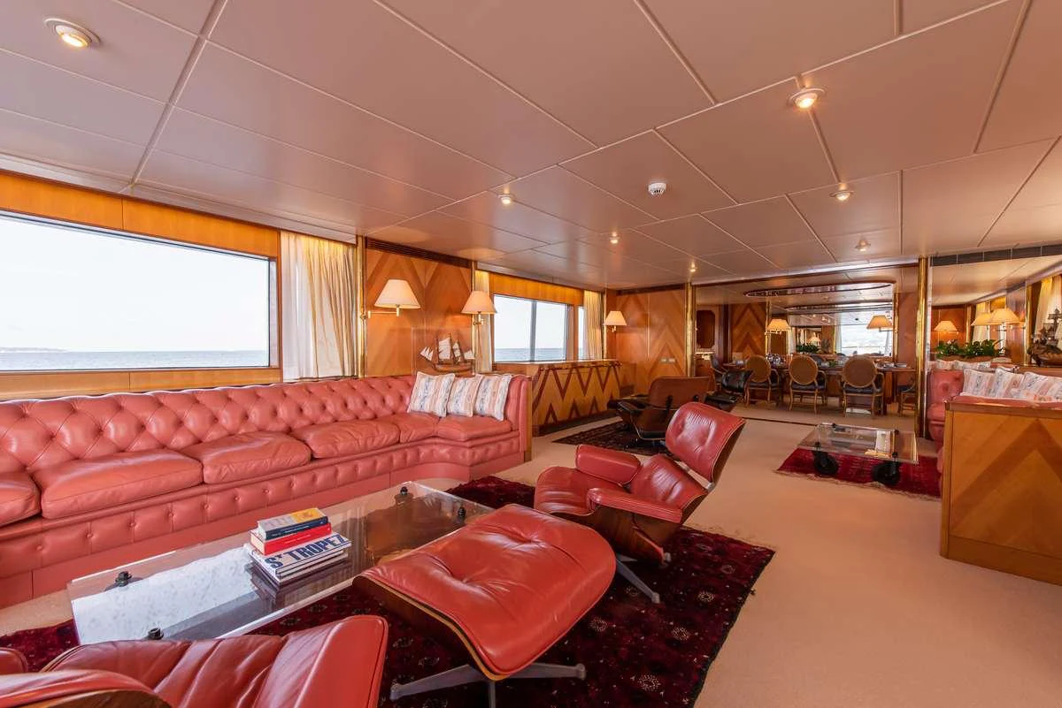 a living room with a red couch aboard SHEERGOLD Yacht for Charter