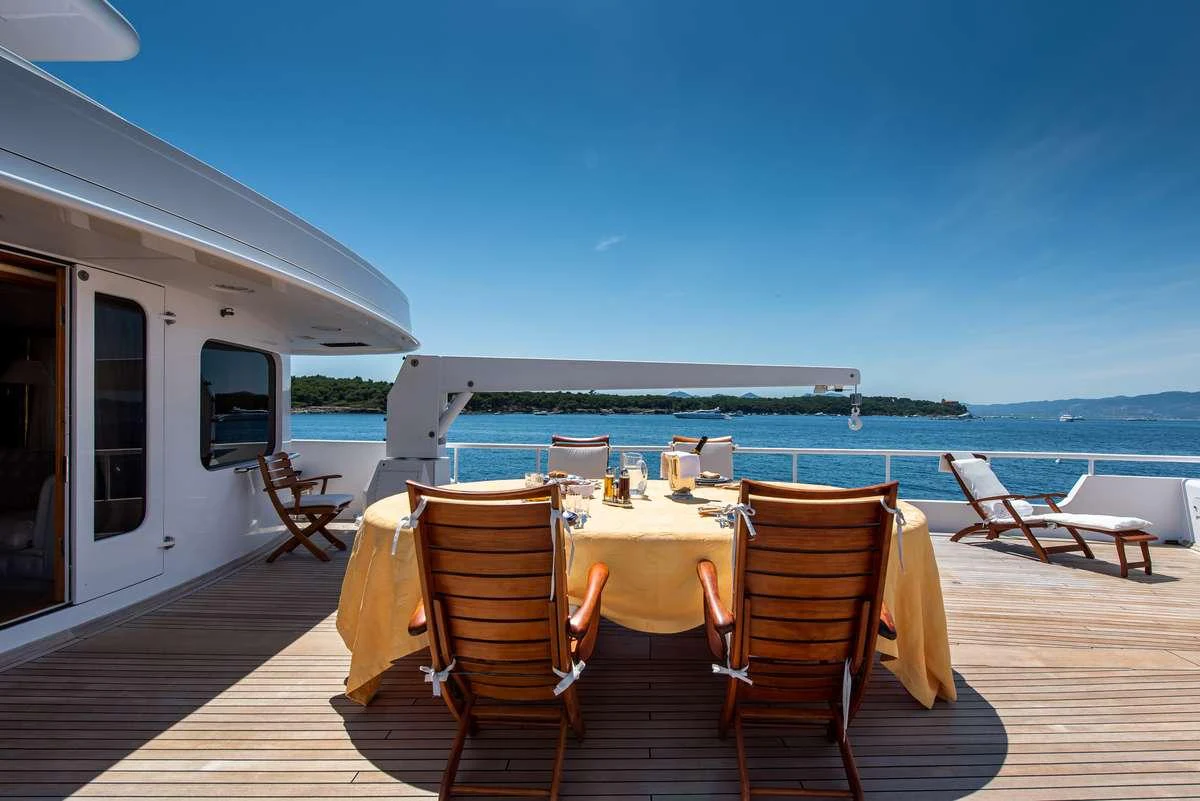 a table and chairs on a deck aboard SHEERGOLD Yacht for Charter