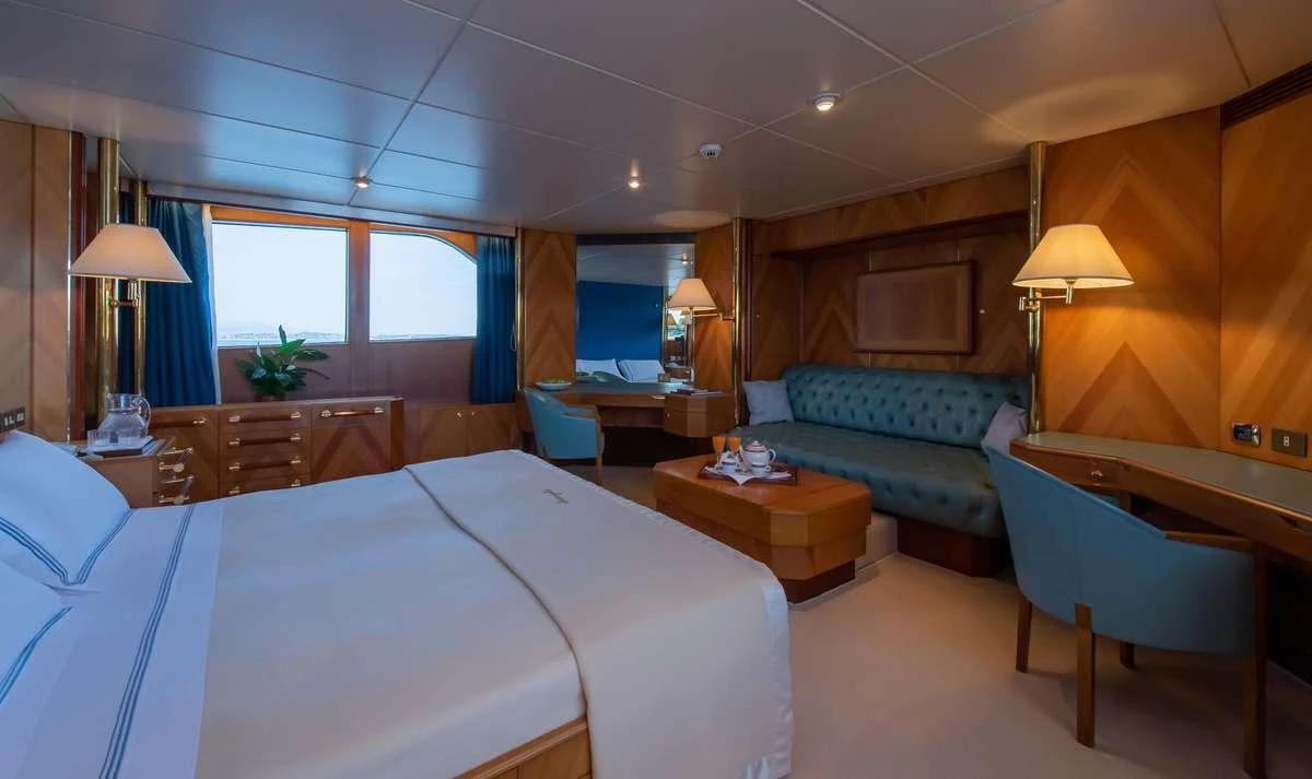 a hotel room with a bed and desk aboard SHEERGOLD Yacht for Charter