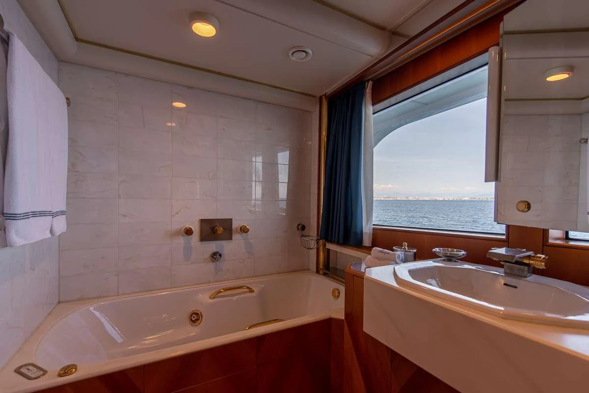 a bathtub and sink in a bathroom aboard SHEERGOLD Yacht for Charter