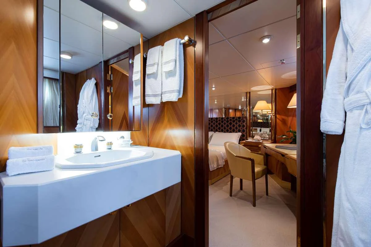 a bathroom with a sink and a mirror aboard SHEERGOLD Yacht for Charter