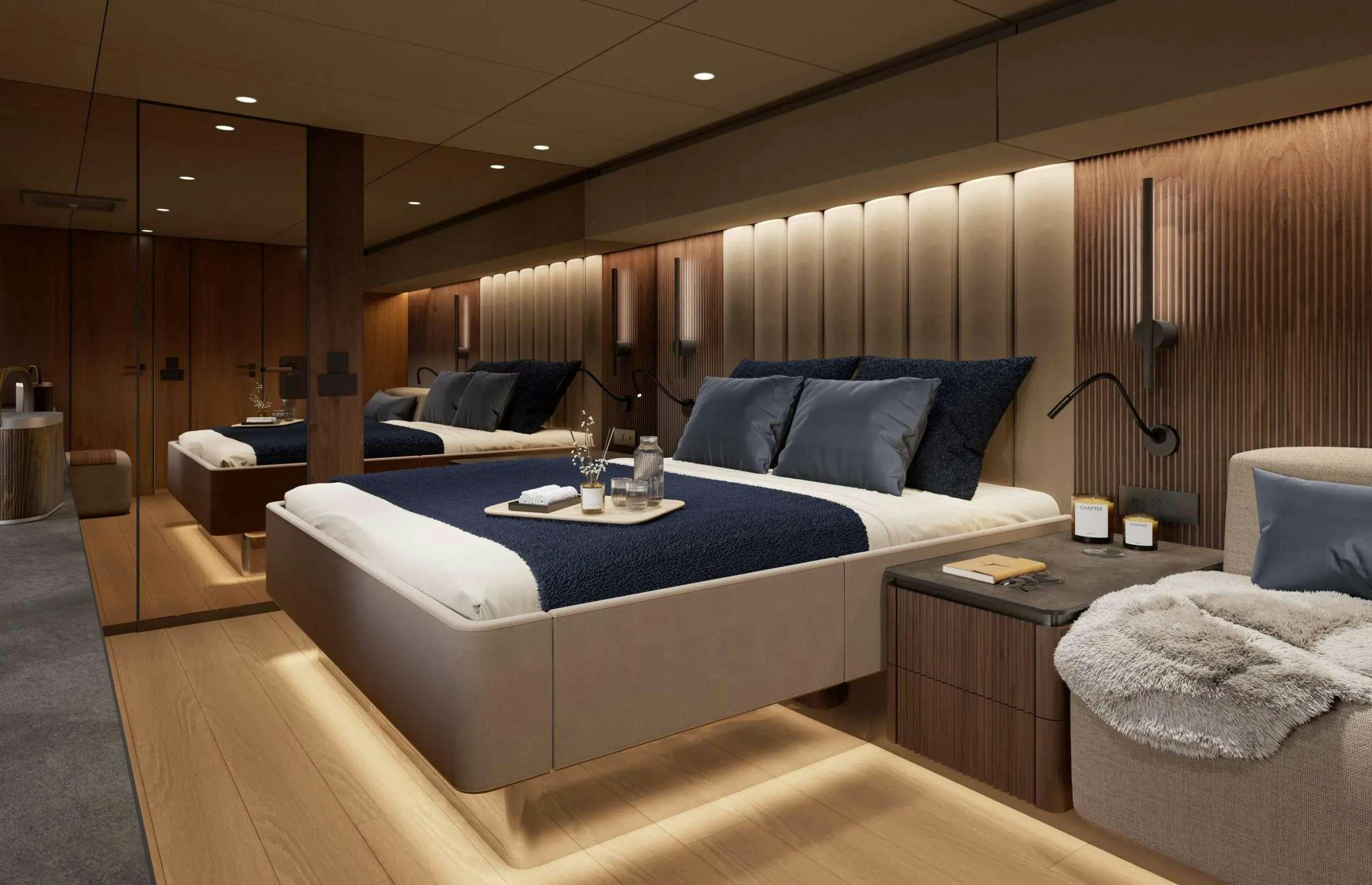 a bed with a blue bed spread aboard AHAVA Yacht for Charter